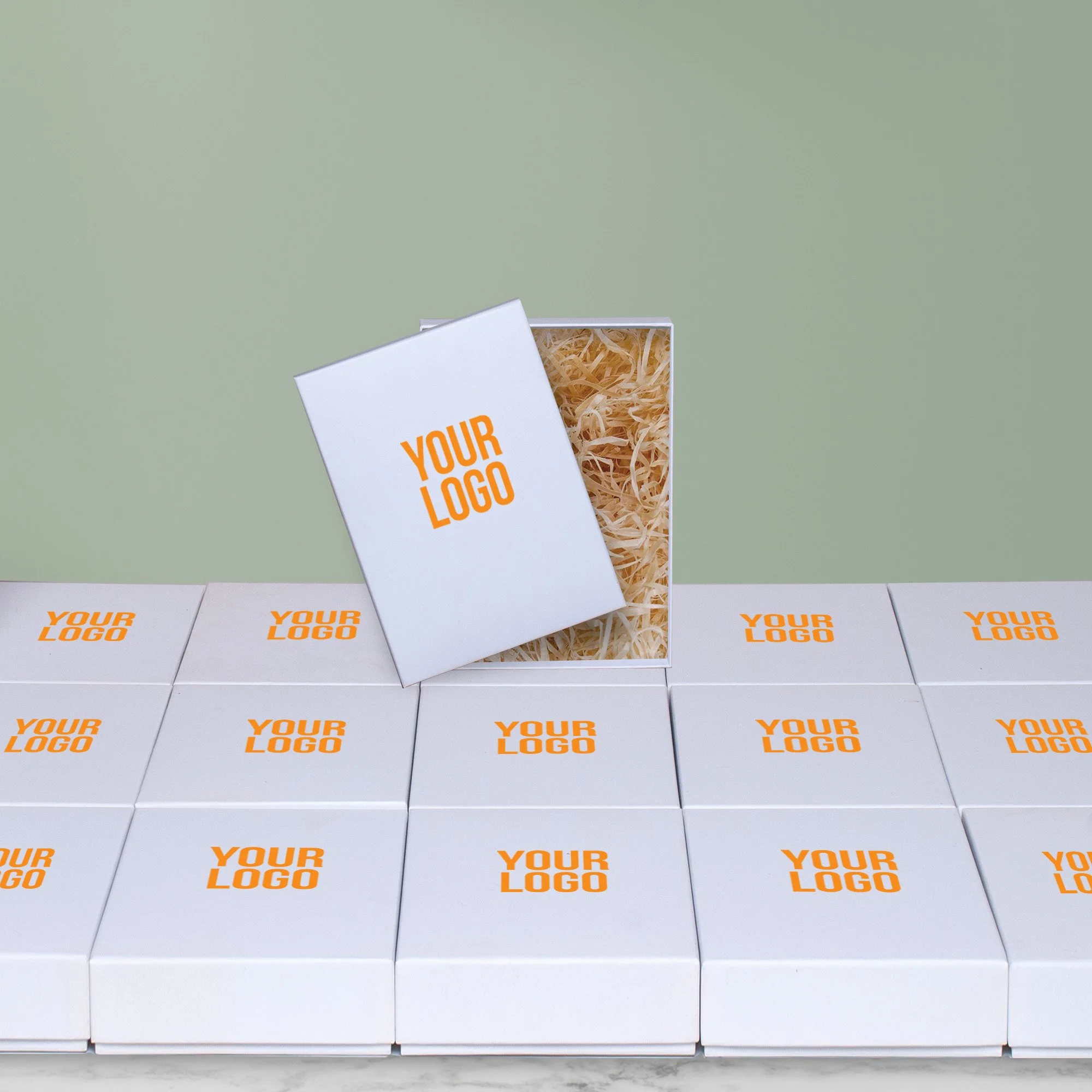Branded corporate hamper boxes arranged at scale with one open gift box showing packing shred.