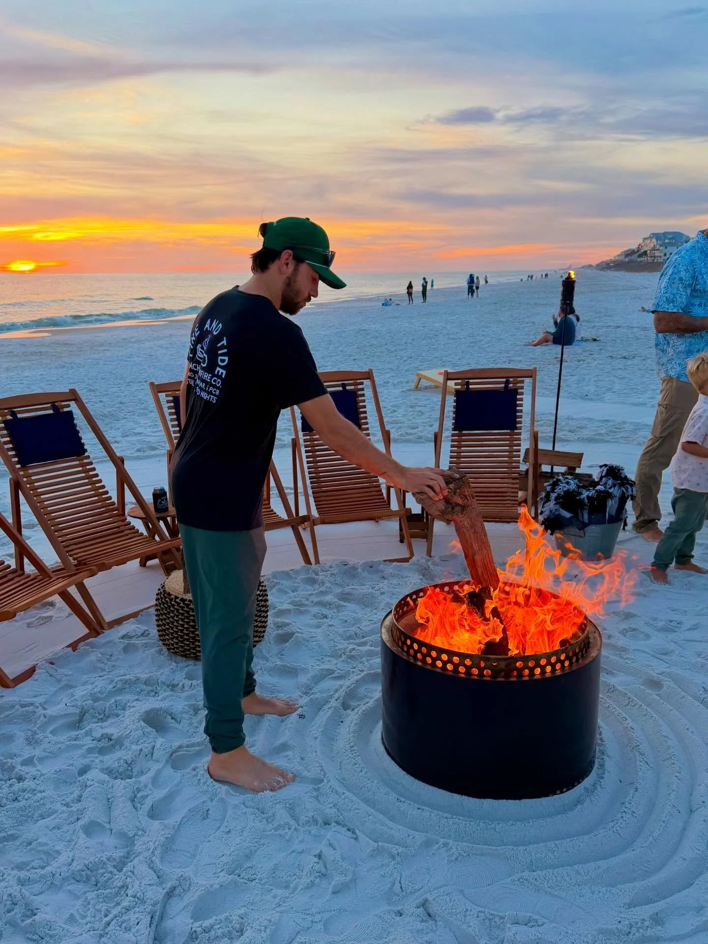 Feeding the flame 🔥 🪵 #beachbonfire #springbreaknights #beachnights #campfire #visitflorida