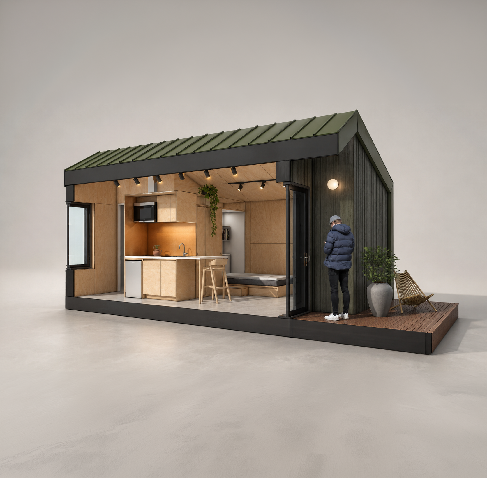 An ADU render with a section cut showing a kitchen and living space inside. The tiny home has a green metal roof, green metal siding, and wooden interior finishes.