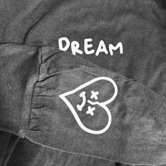Gray sweatshirt with the word 'DREAM' and a heart-shaped graphic with a sleeping face inside.