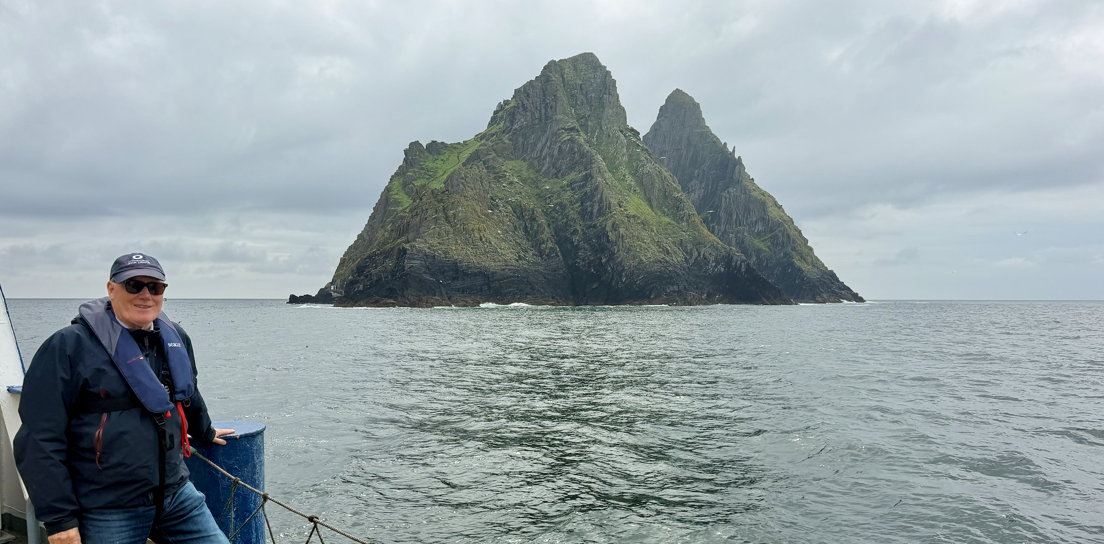 Dan Maher standing on the Granuaile beside Skellig Michael