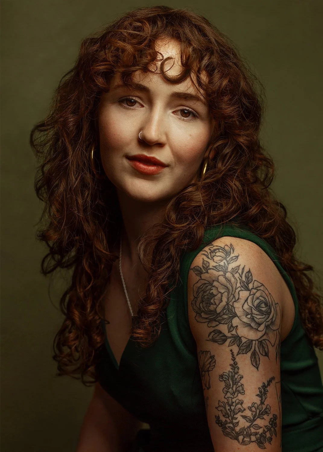young-woman-green-dress-curly-hair-tattoos-headshot-photography.jpg