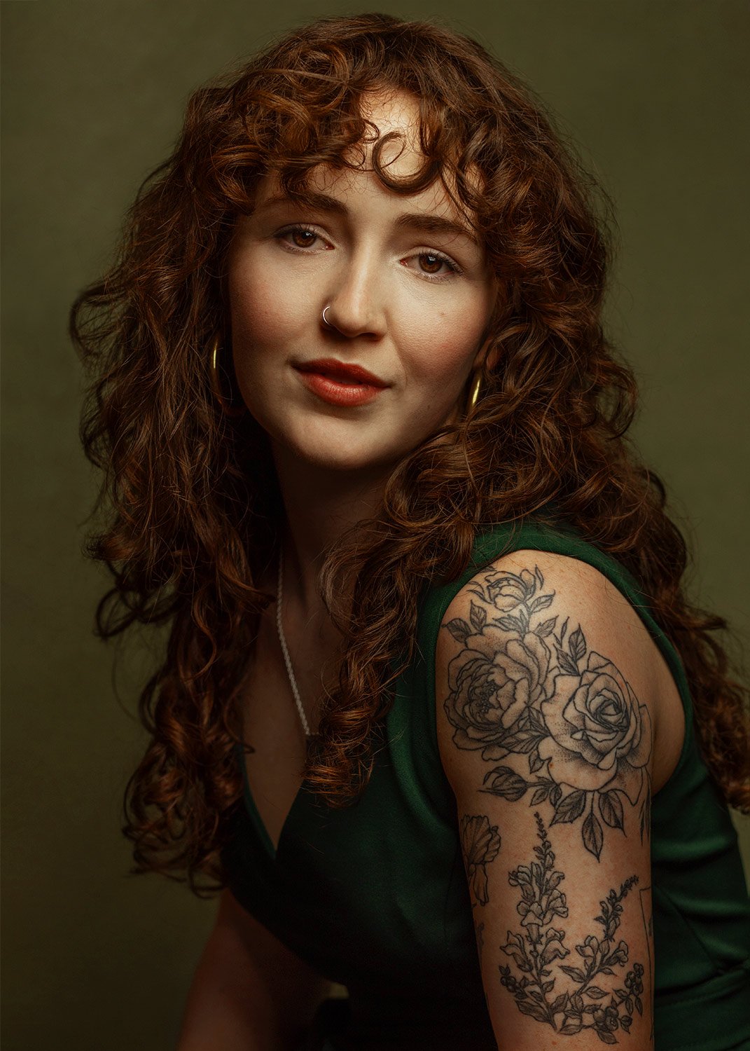 young-woman-green-dress-curly-hair-tattoos-headshot-photography.jpg