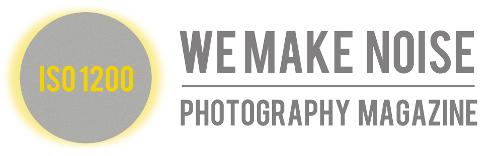 A digital camera lens with a yellow badge reading "ISO 1200" on the side.