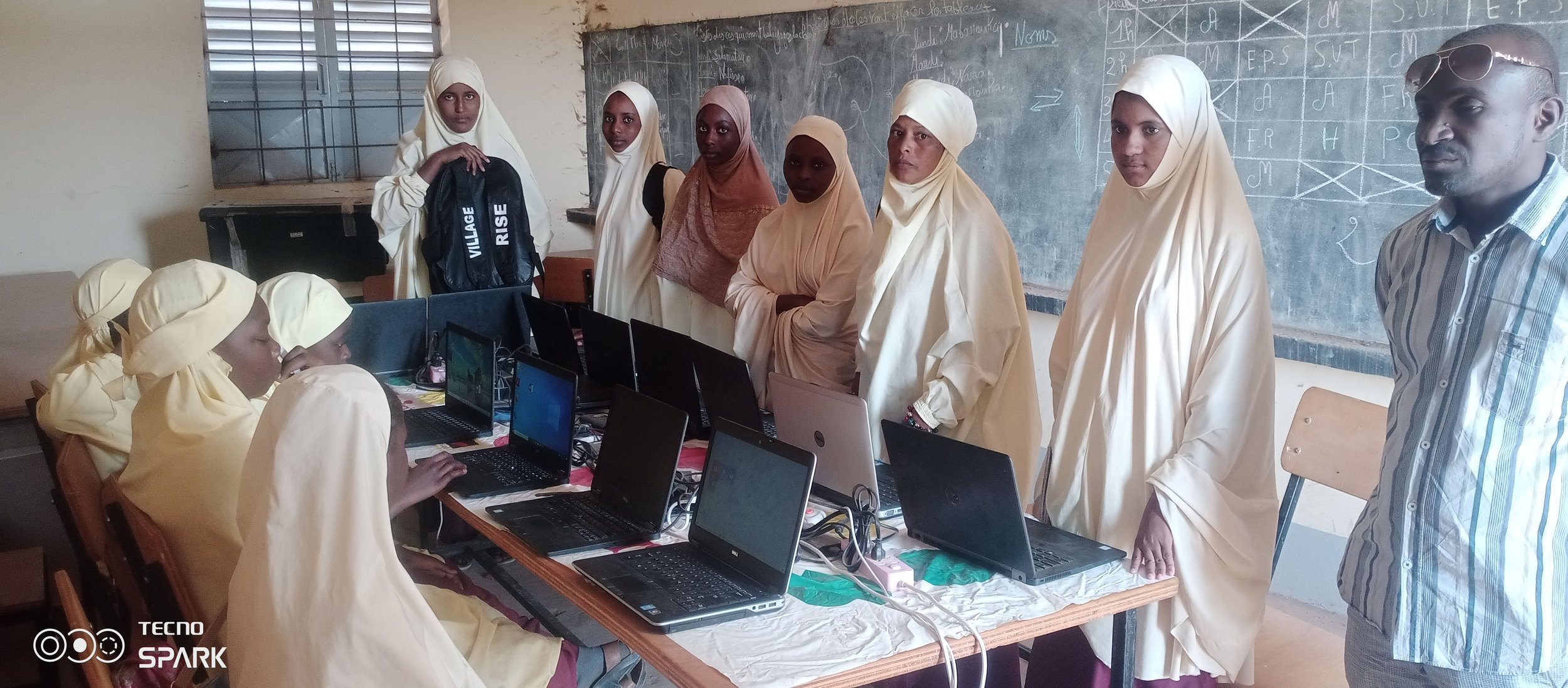 Photo taken with an HGEC teacher in the computer training room. Those standing are our students 2.jpg