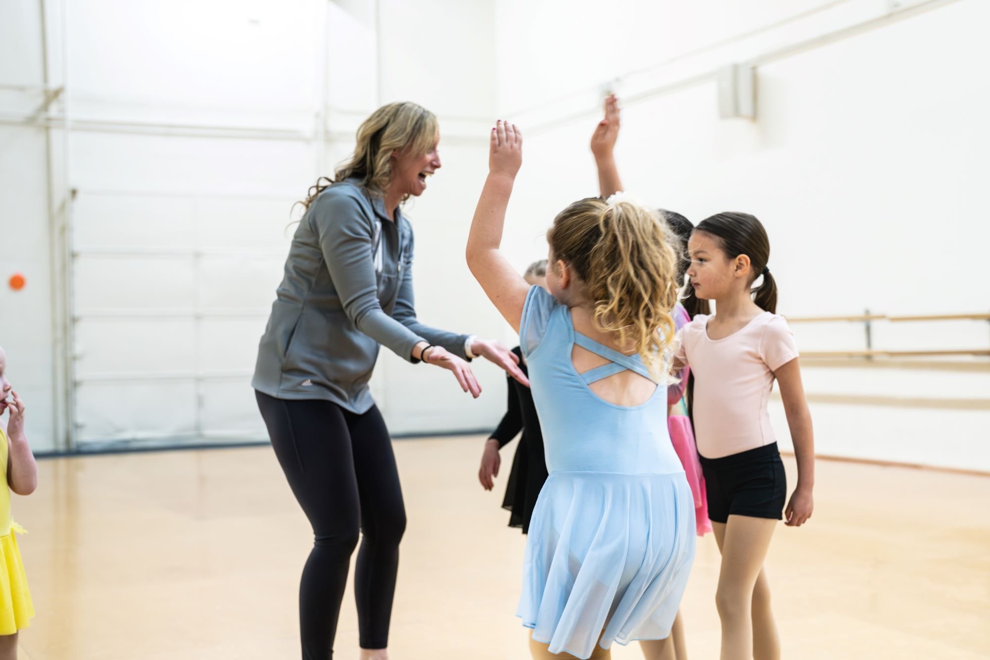 Young dancers high-fiving Bethany at BCD.