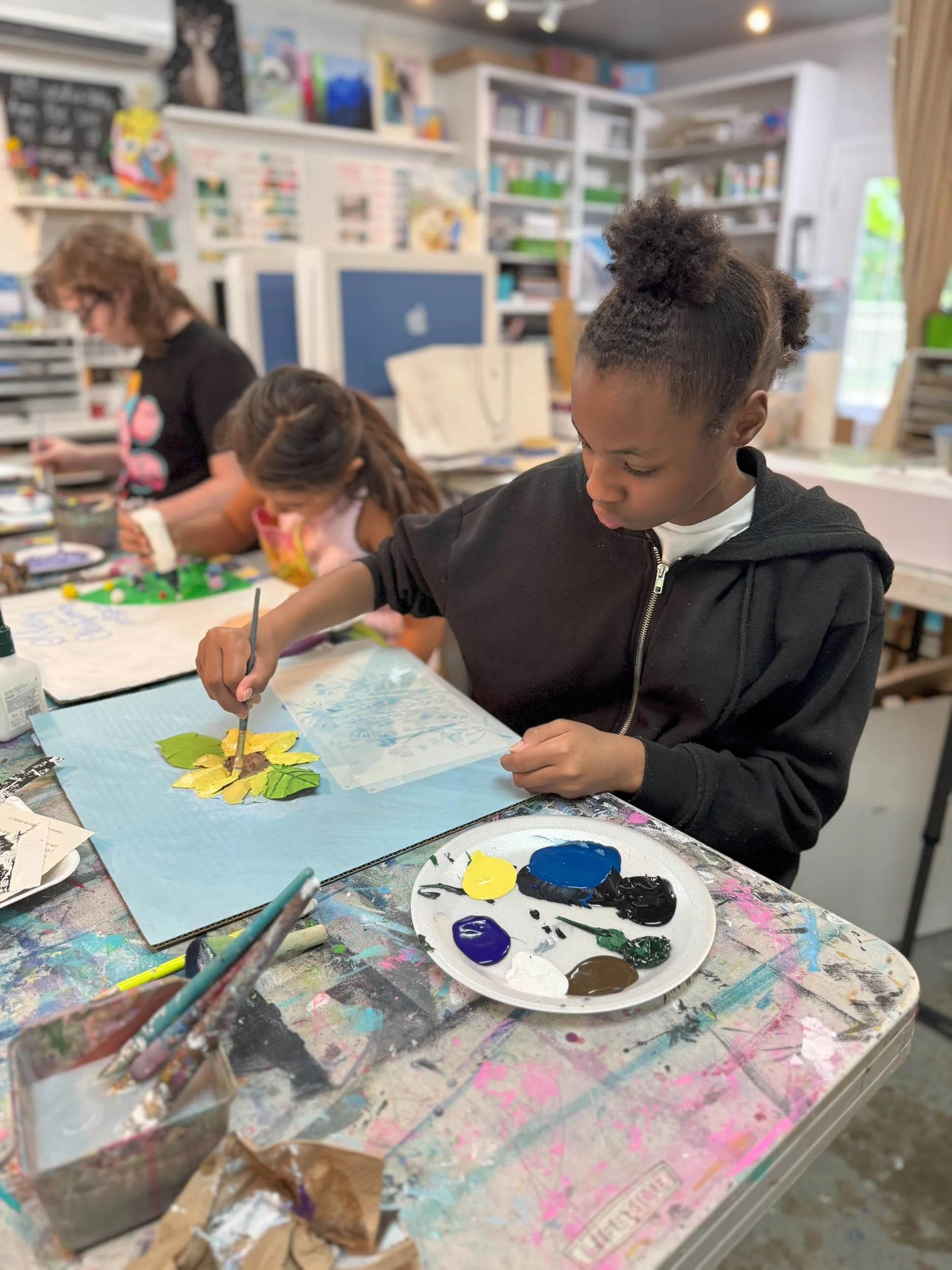 Children making mixed media art at The Marshall Muse Gallery during art camp.