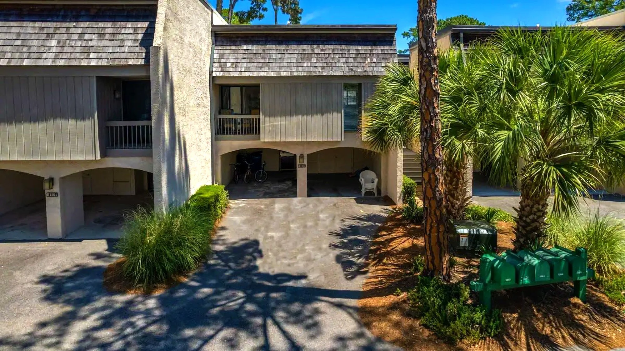 Duplex with covered parking and palm trees