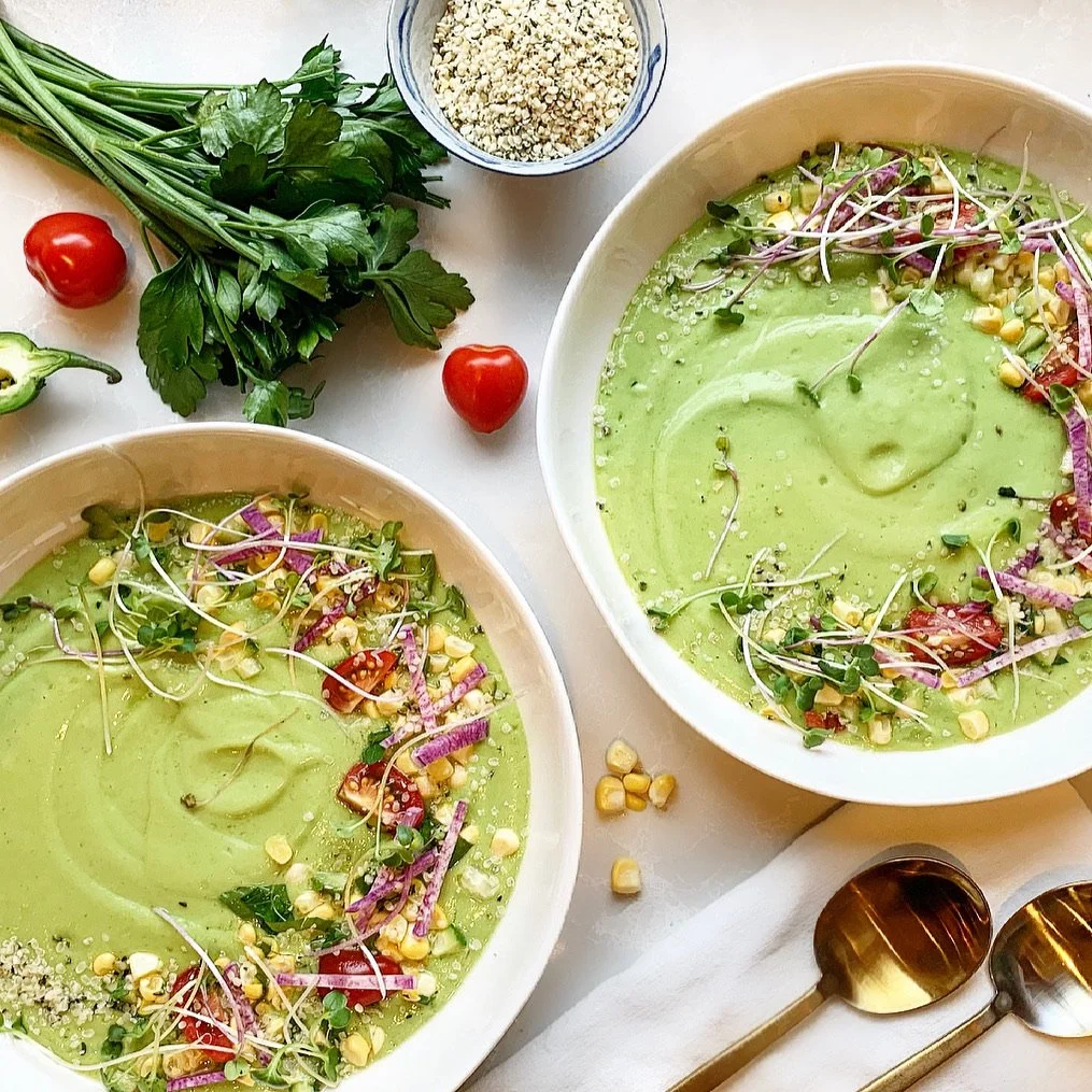 Chilled green soup with avocado, herbs, tomatoes, corn, and olive oil.