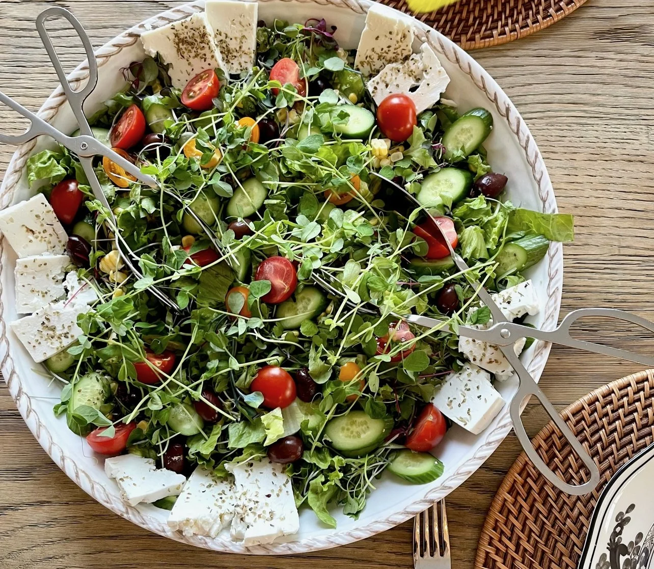 Greek salad with cucumbers, tomatoes, feta, olives, and olive oil for an online cooking class.