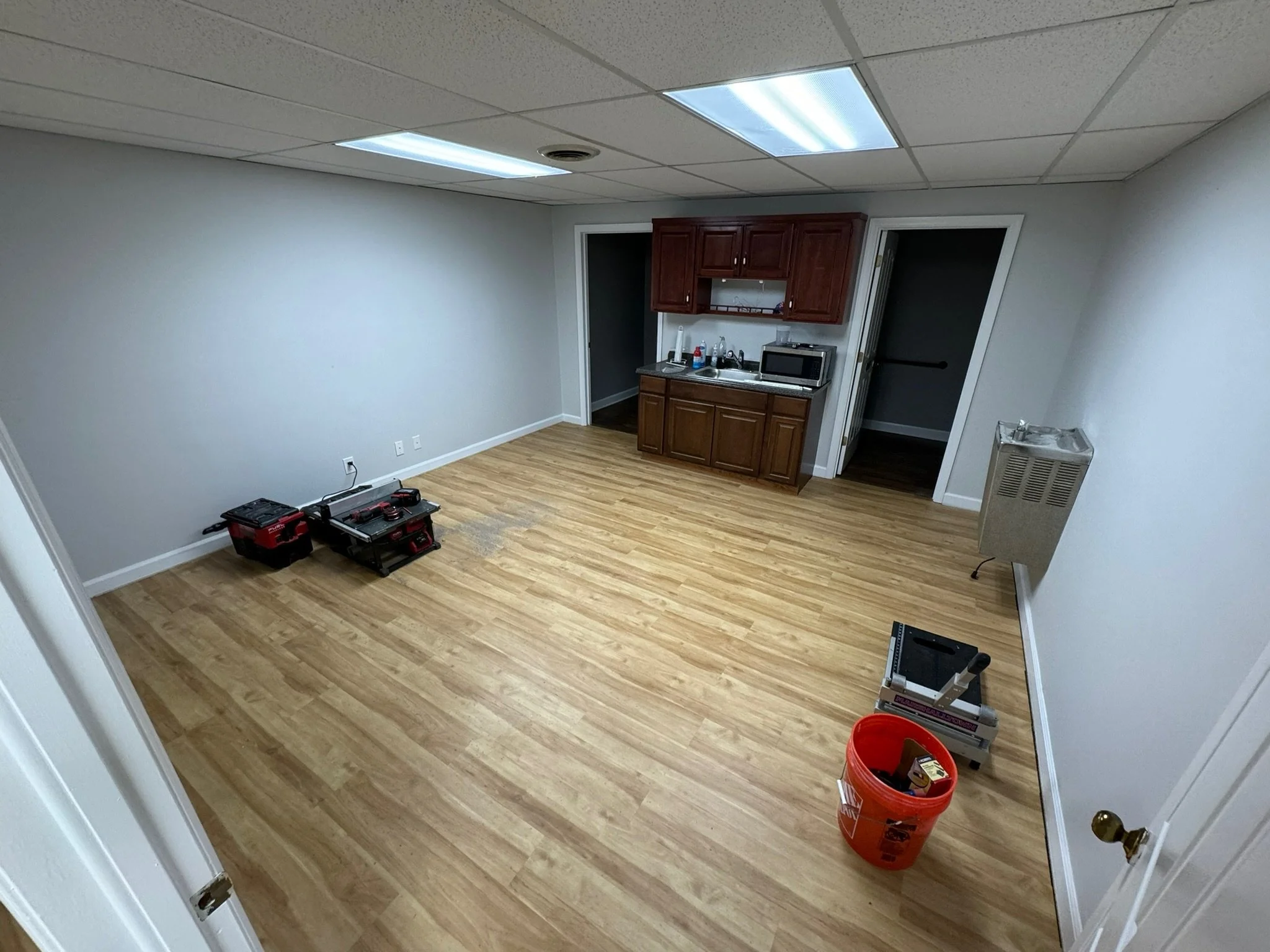 Warehouse office kitchen upgrade - fresh paint throughout, flooring, and lighting upgrades.