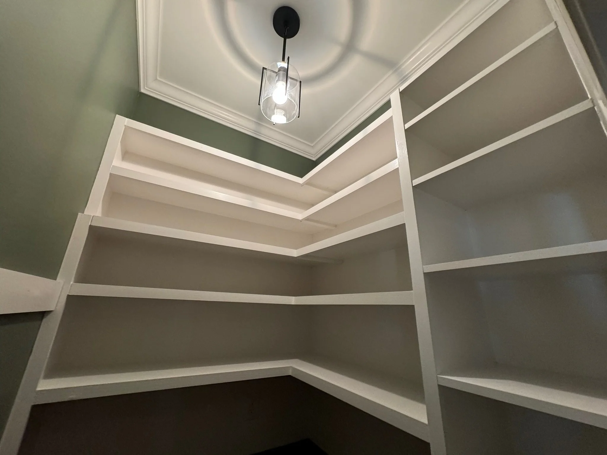 Custom pantry/coffee nook - custom shelving, butcher block countertop, crown moulding, lighting, paint, stain, and varnish. 