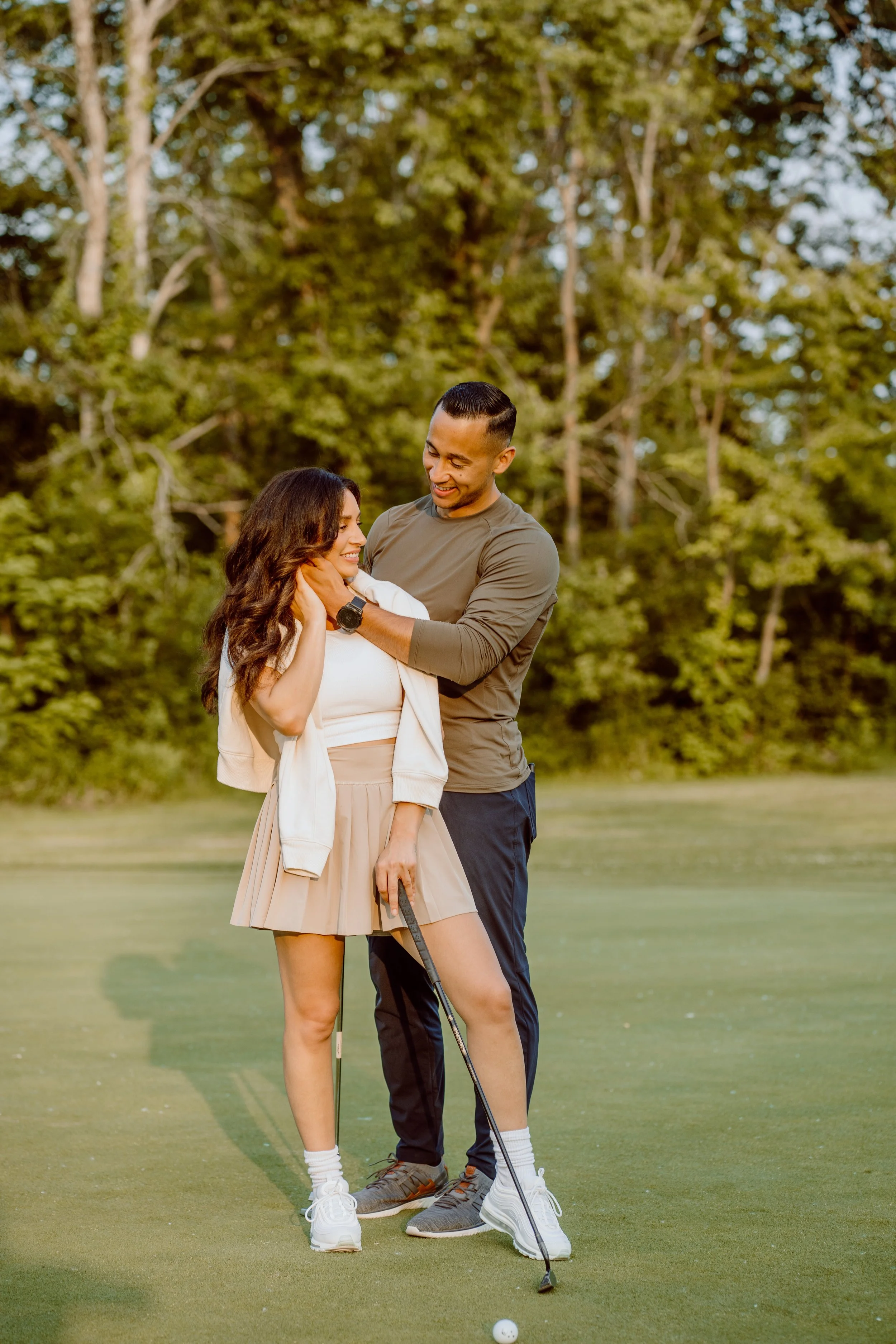 Couple embracing during a golden hour couples session in an open field near Sarasota, Florida.
