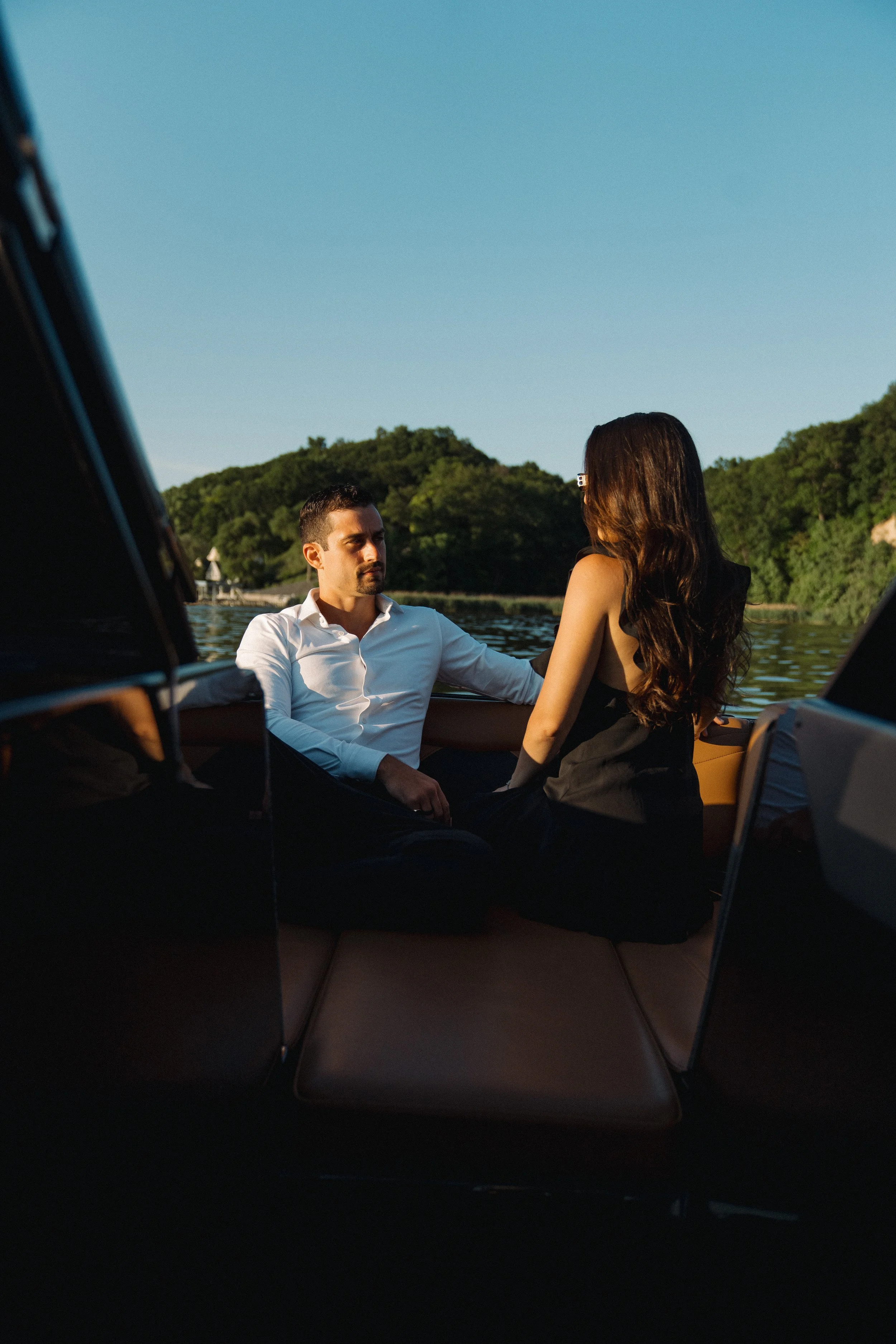 Couple enjoying a romantic sunset boat engagement session in Sarasota, Florida.