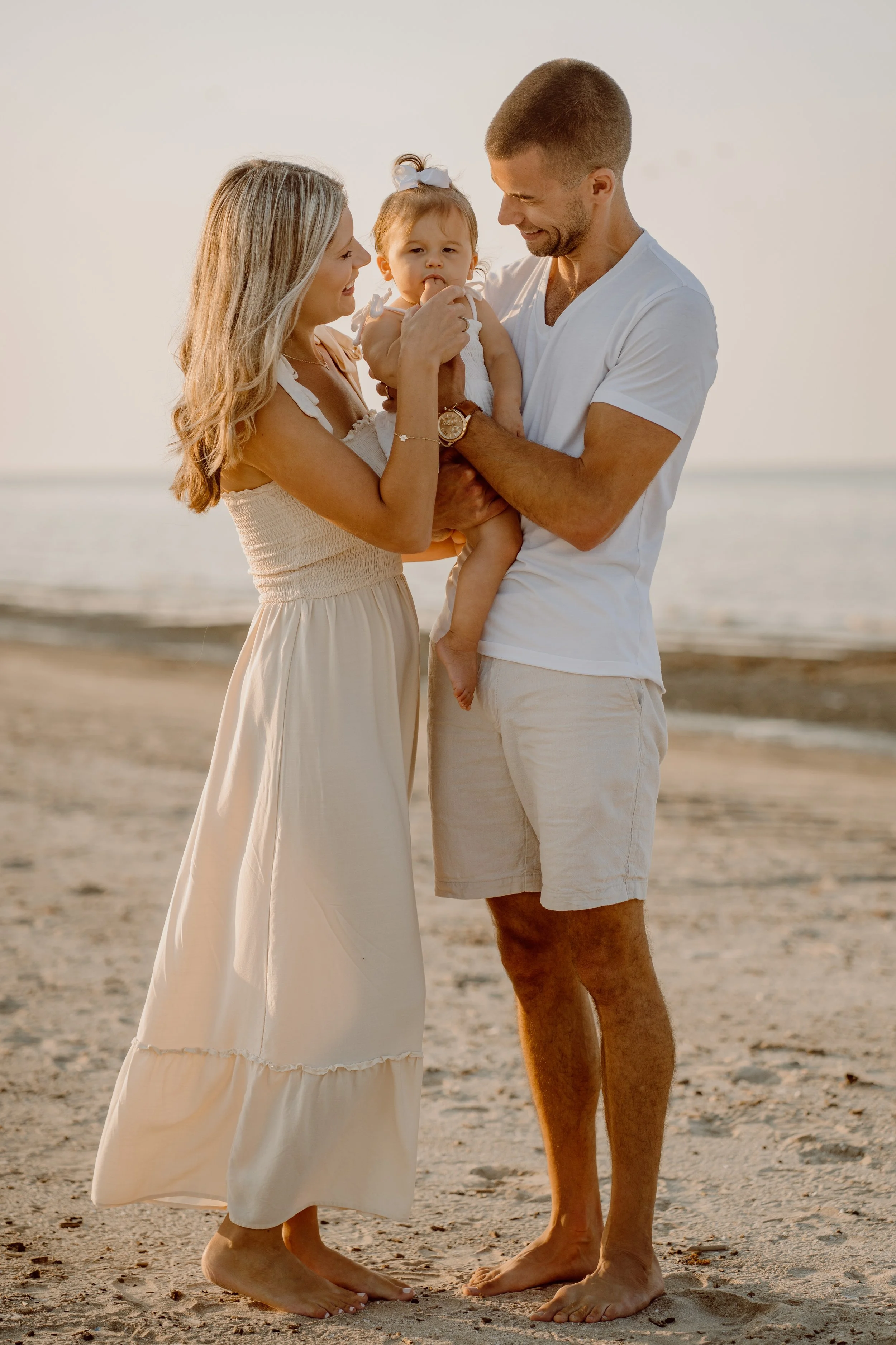 Mother and child embracing on the beach during a natural lifestyle photography session in Florida.