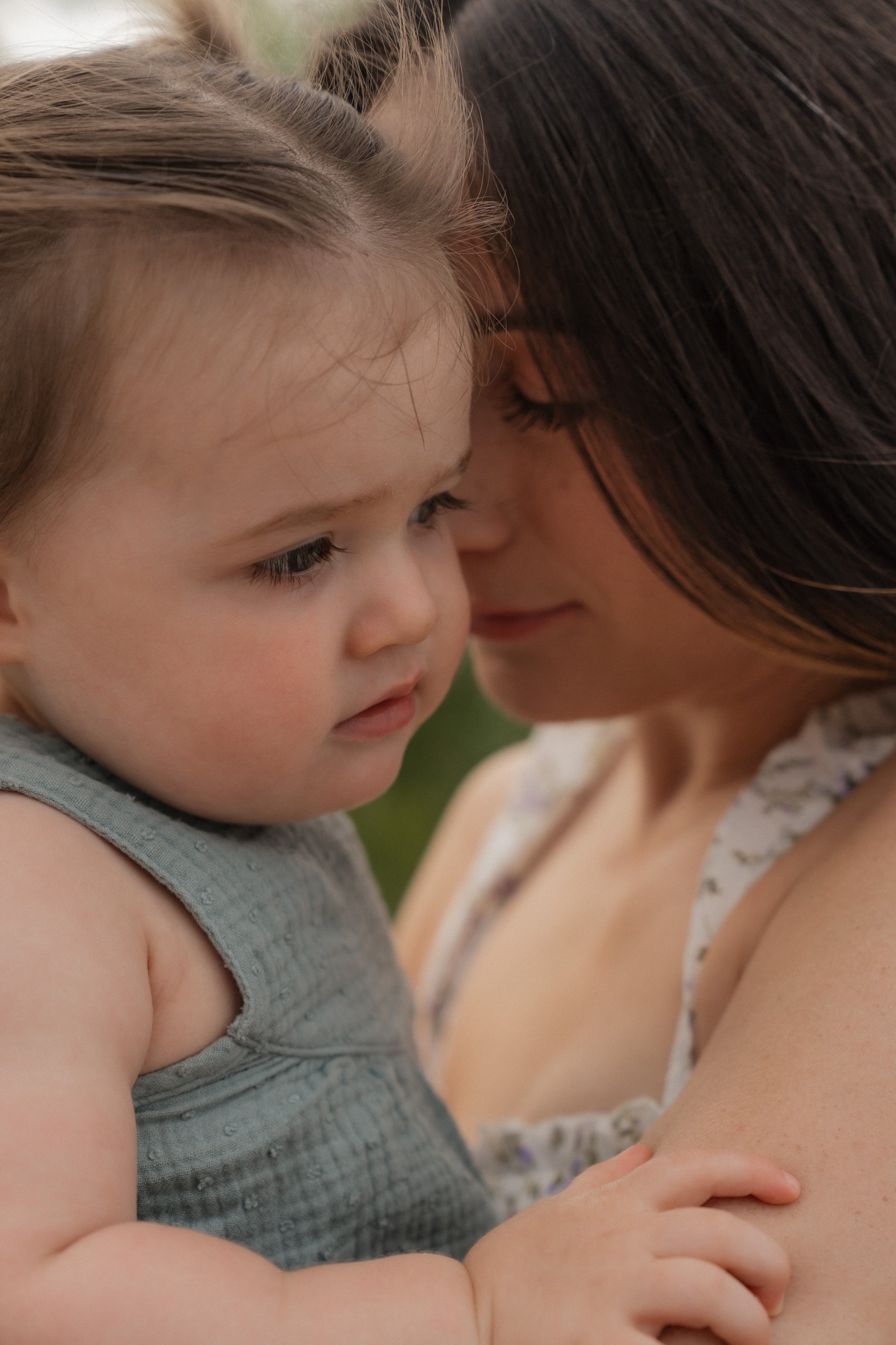 Mother and child embracing on the beach during a natural lifestyle photography session in Florida.