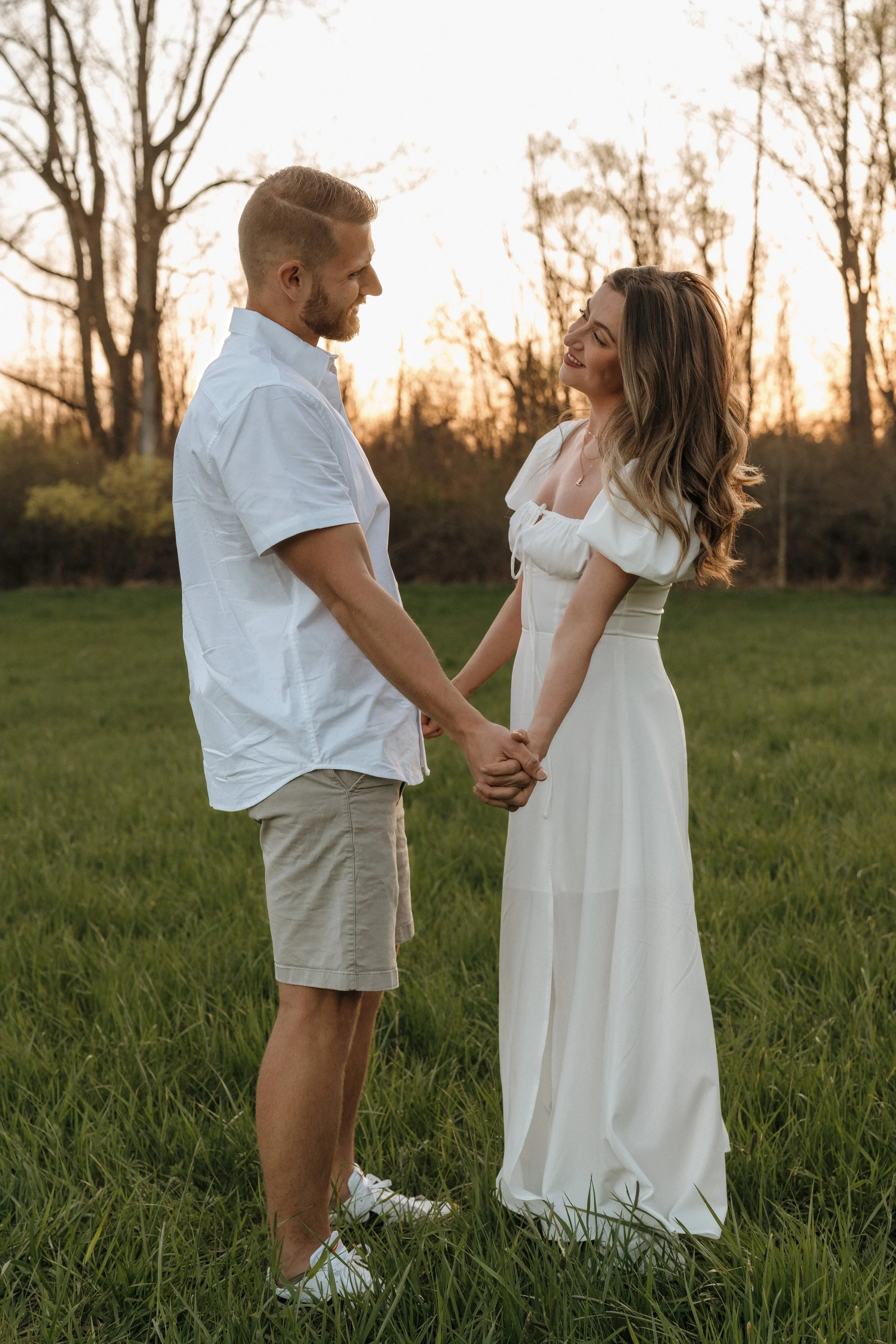 Couple sharing a quiet moment during a golden hour engagement session in Bradenton, Florida.