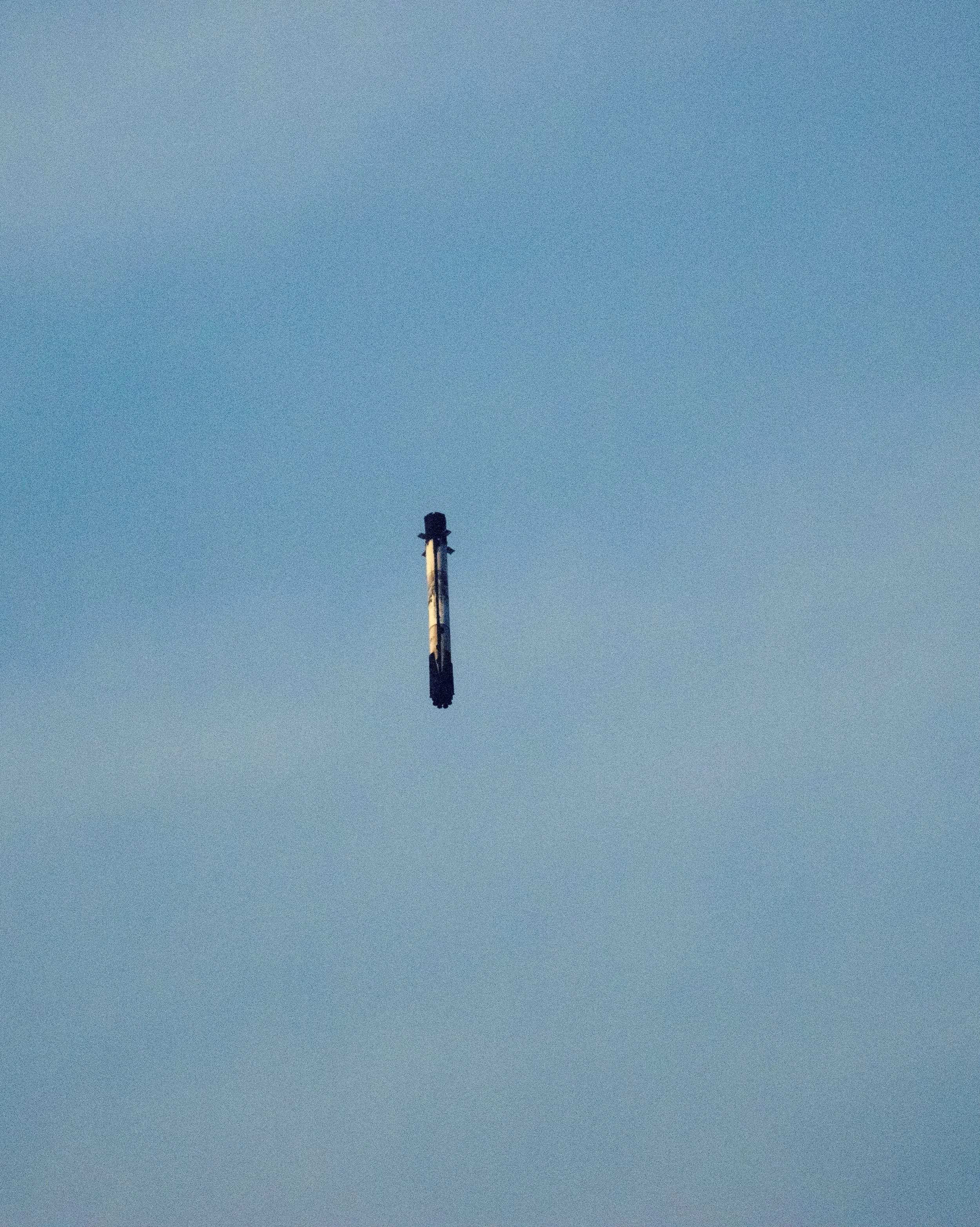 A crowbar floating against a clear blue sky.