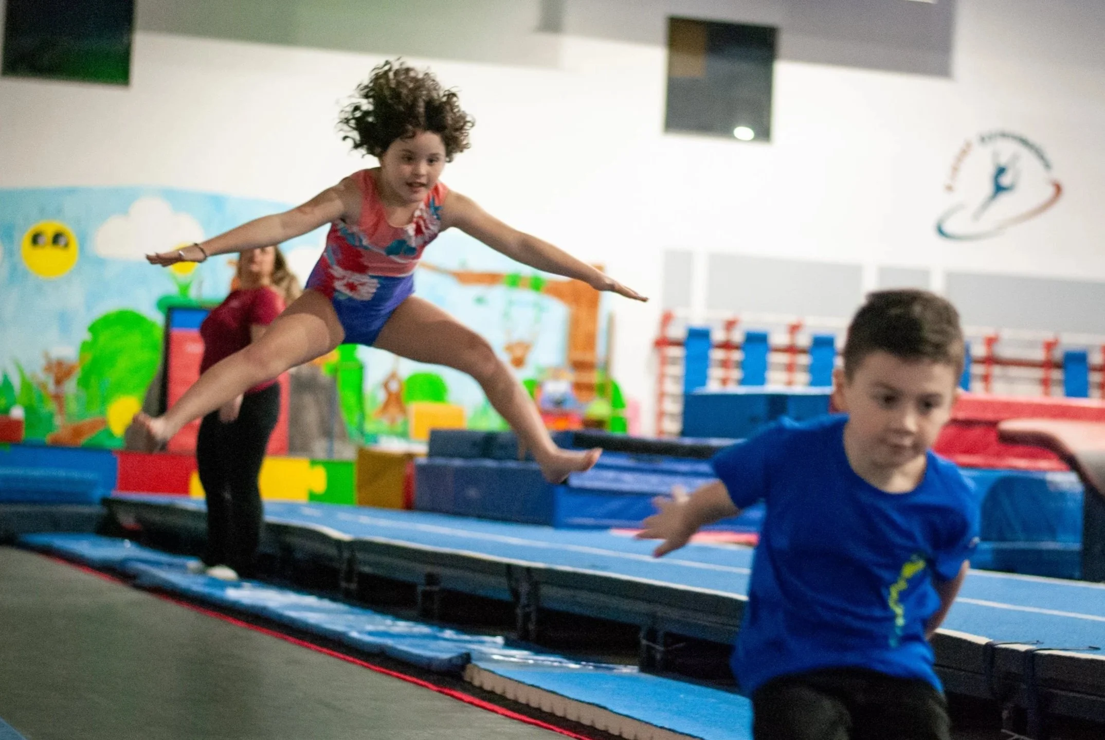 Gymnasts practicing their jumps on our 50 ft. long tumble track.