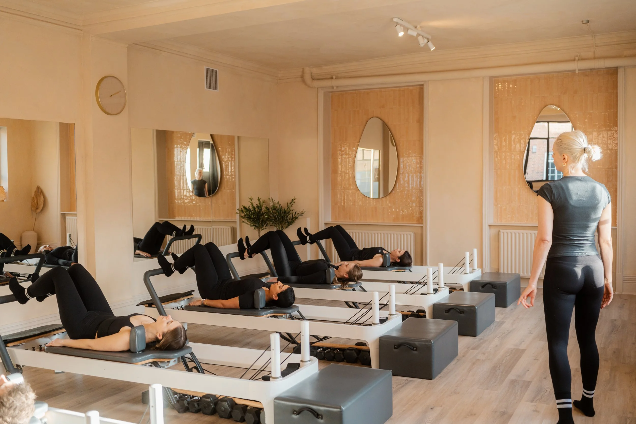 Clients doing beginner Reformer Pilates