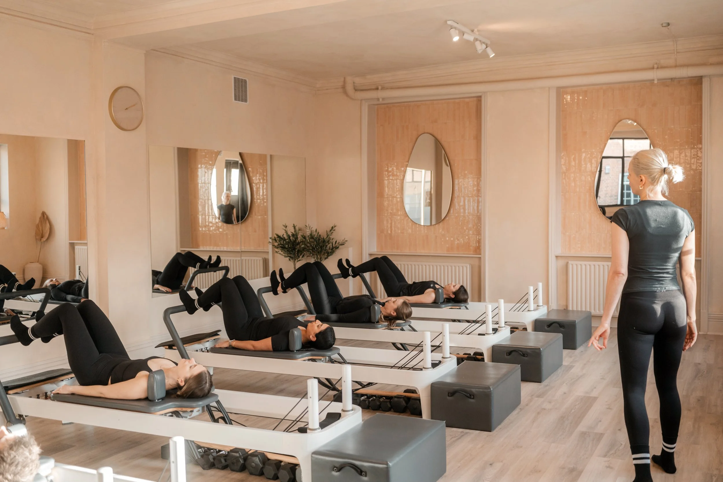 Clients doing beginner Reformer Pilates