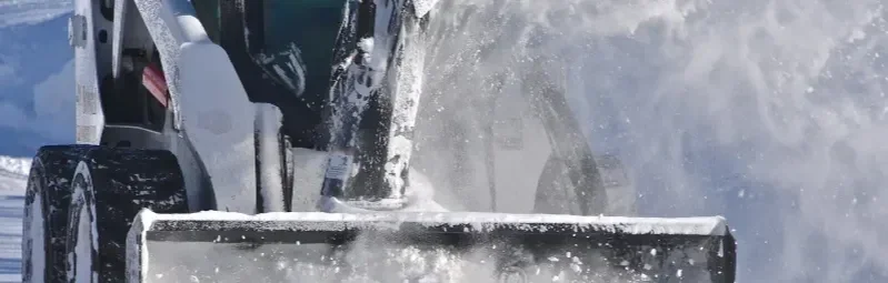 skid-steer-blowing-snow-skid-steer-attached-snow-blower-clears-path-deep-snow-suburban-neighborhood-142106236.webp