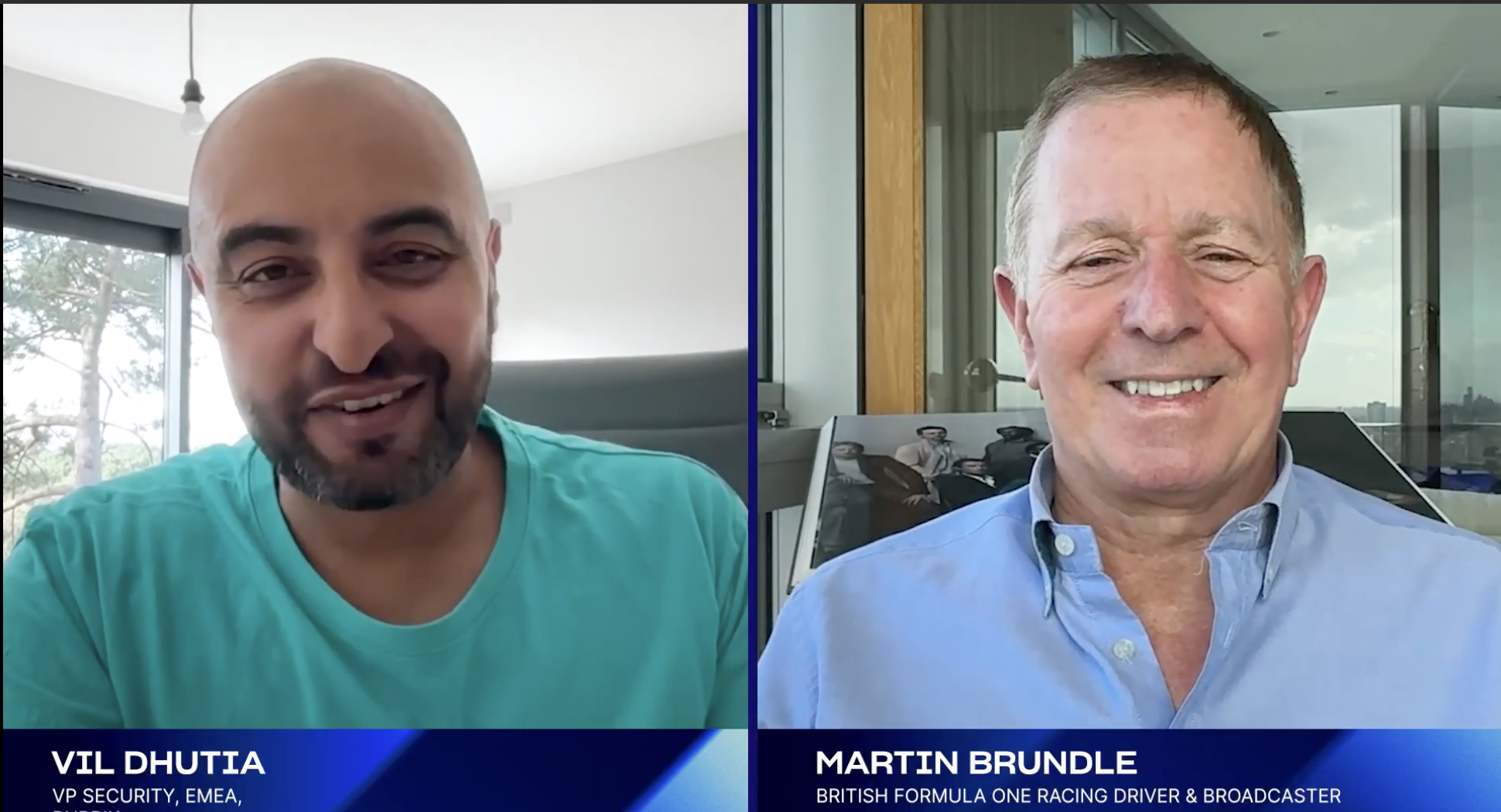 Side-by-side video interview with Vil Dhutia, VP Security at EMEA, on the left, and Martin Brundle, a British Formula One racing driver and broadcaster, on the right. Both are smiling, and the background includes windows and office or balcony setting.