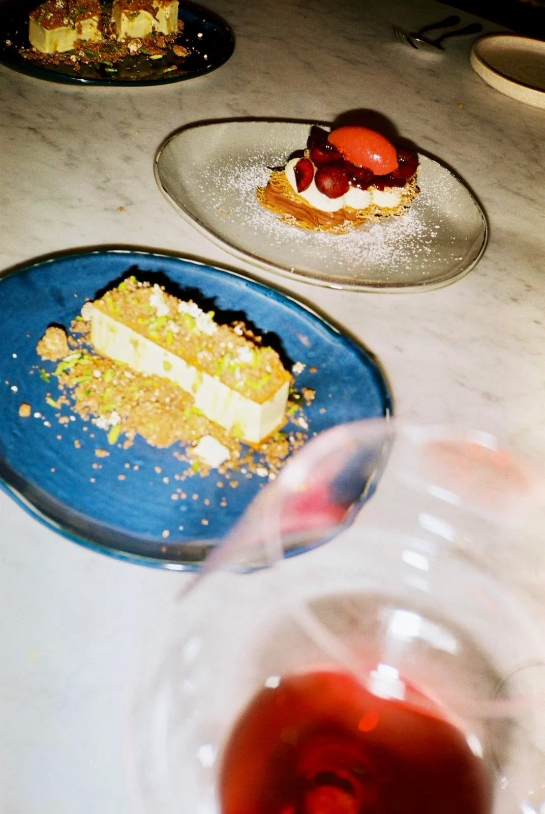 Plating a strawberry dessert for a private dinner party catered by Trestle in Melbourne