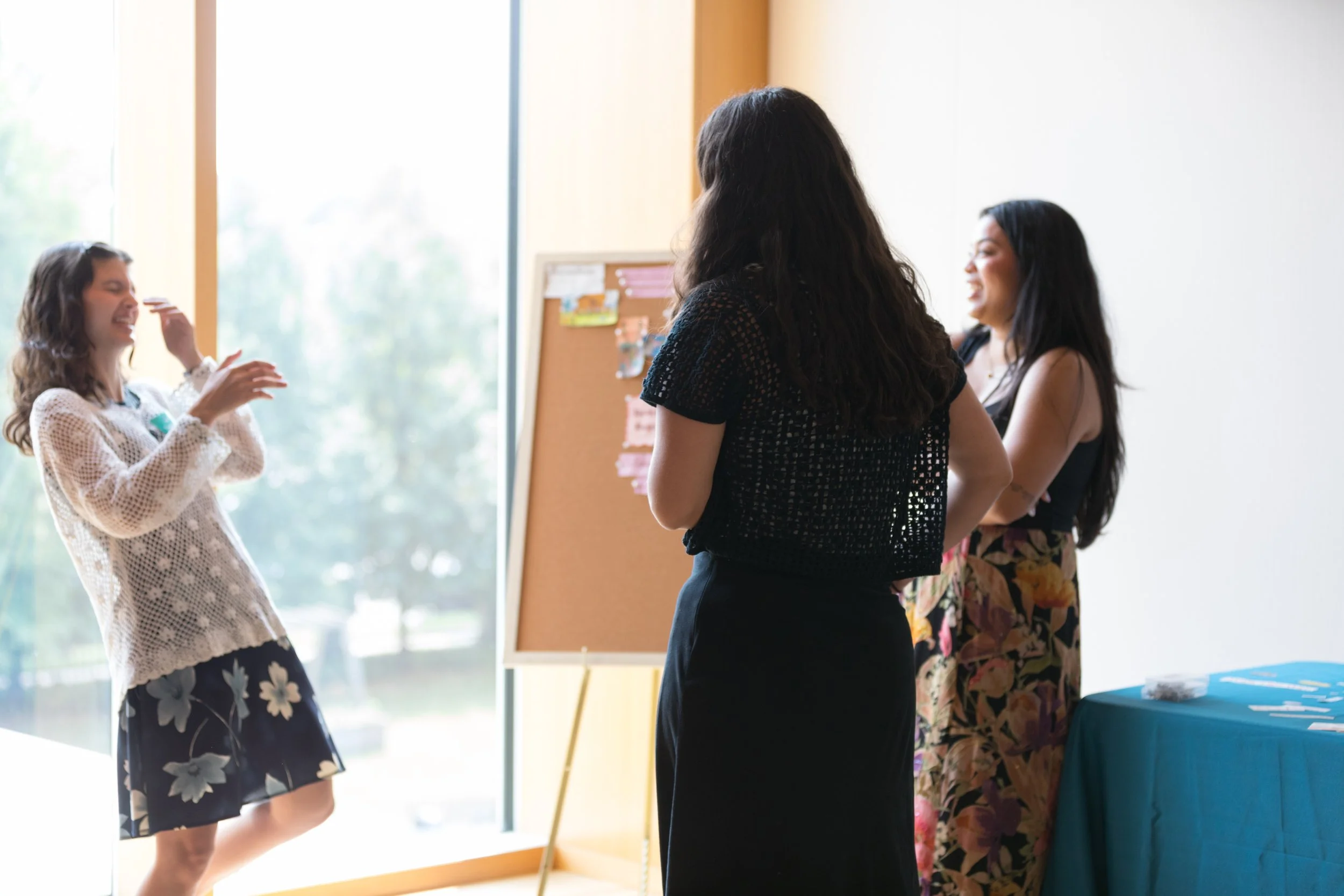  Three current fellows share a laugh as they get ready to present. 