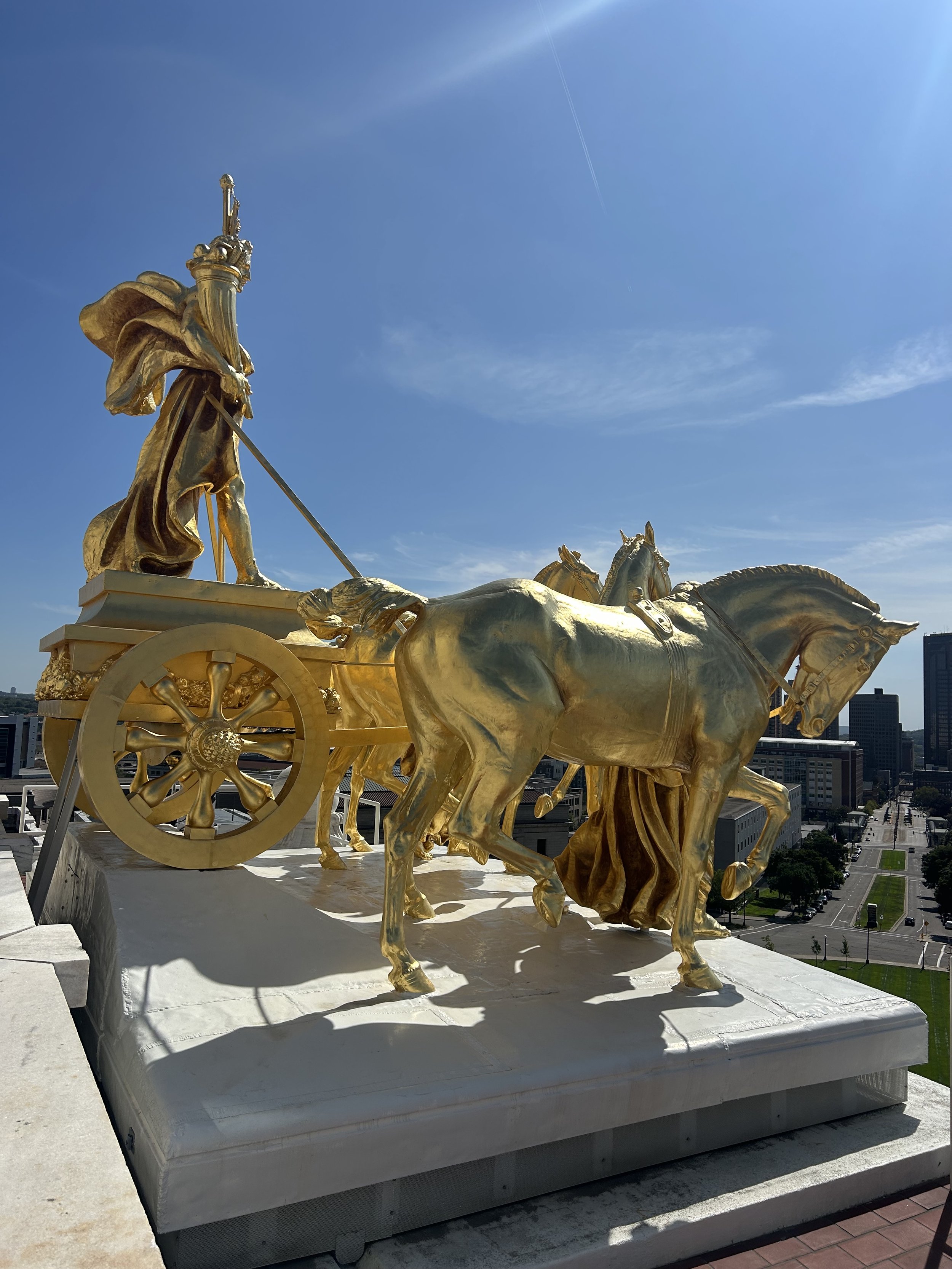 Four gold horses pulling a chariot look out over Saint Paul.