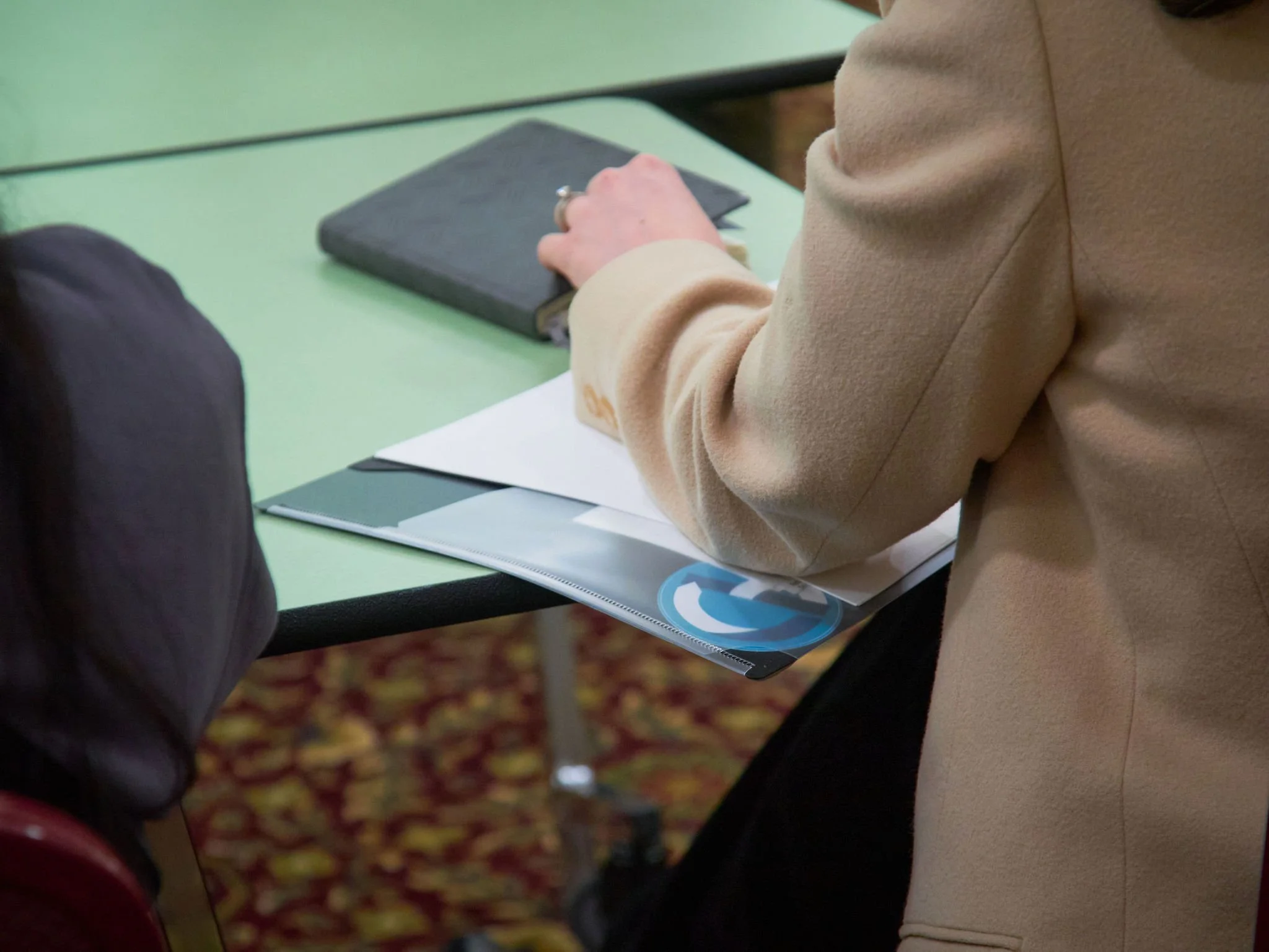 Two people looking and pointing at paper.