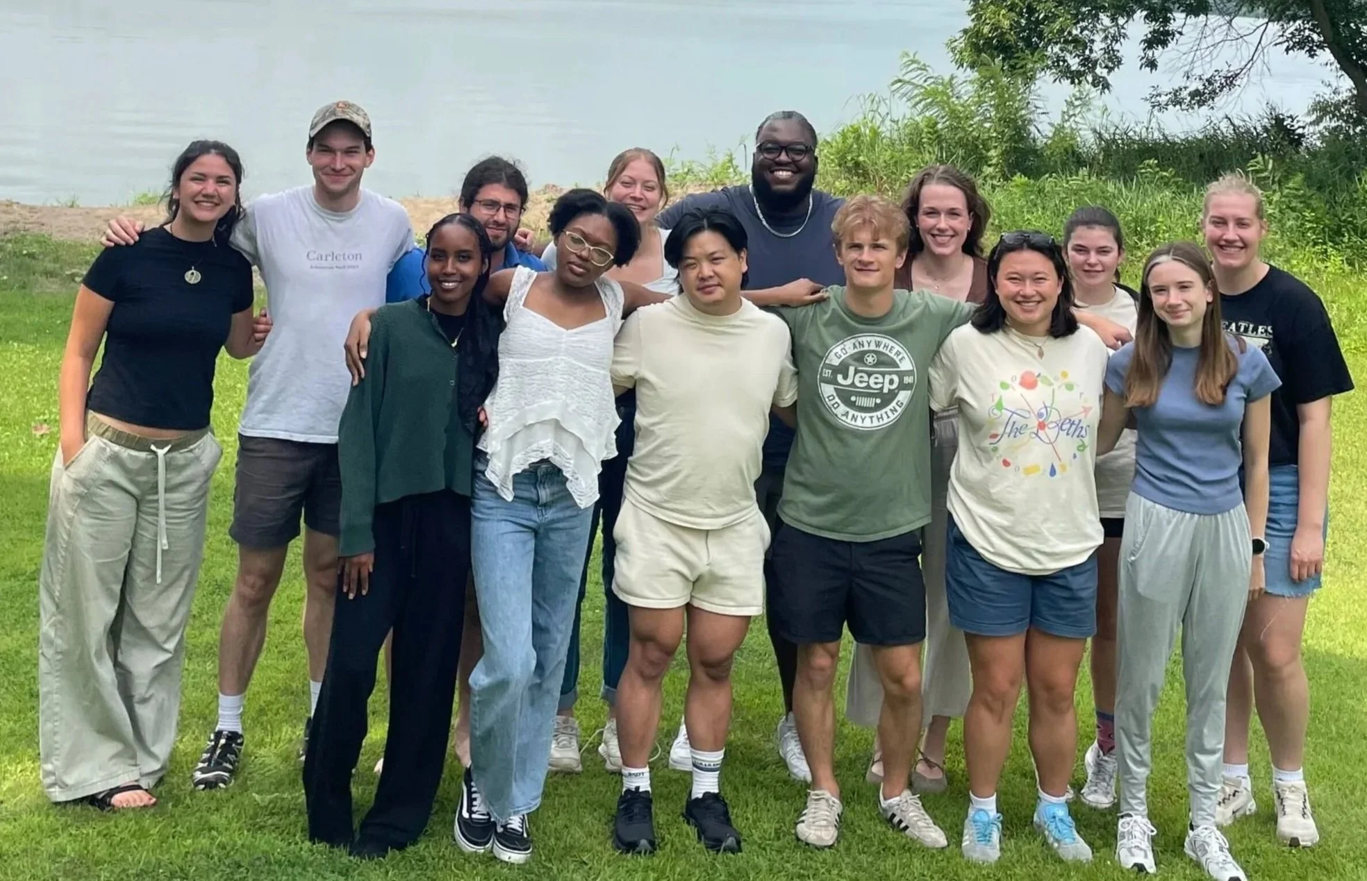Members of the 2026-27 Fellowship cohort pose for a photo in front of the lake at Metta Meditation Center.