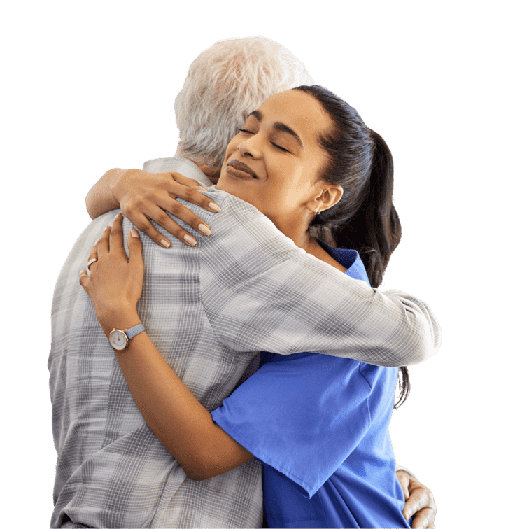 A young woman in a blue shirt hugging an older man in a plaid shirt, both smiling.