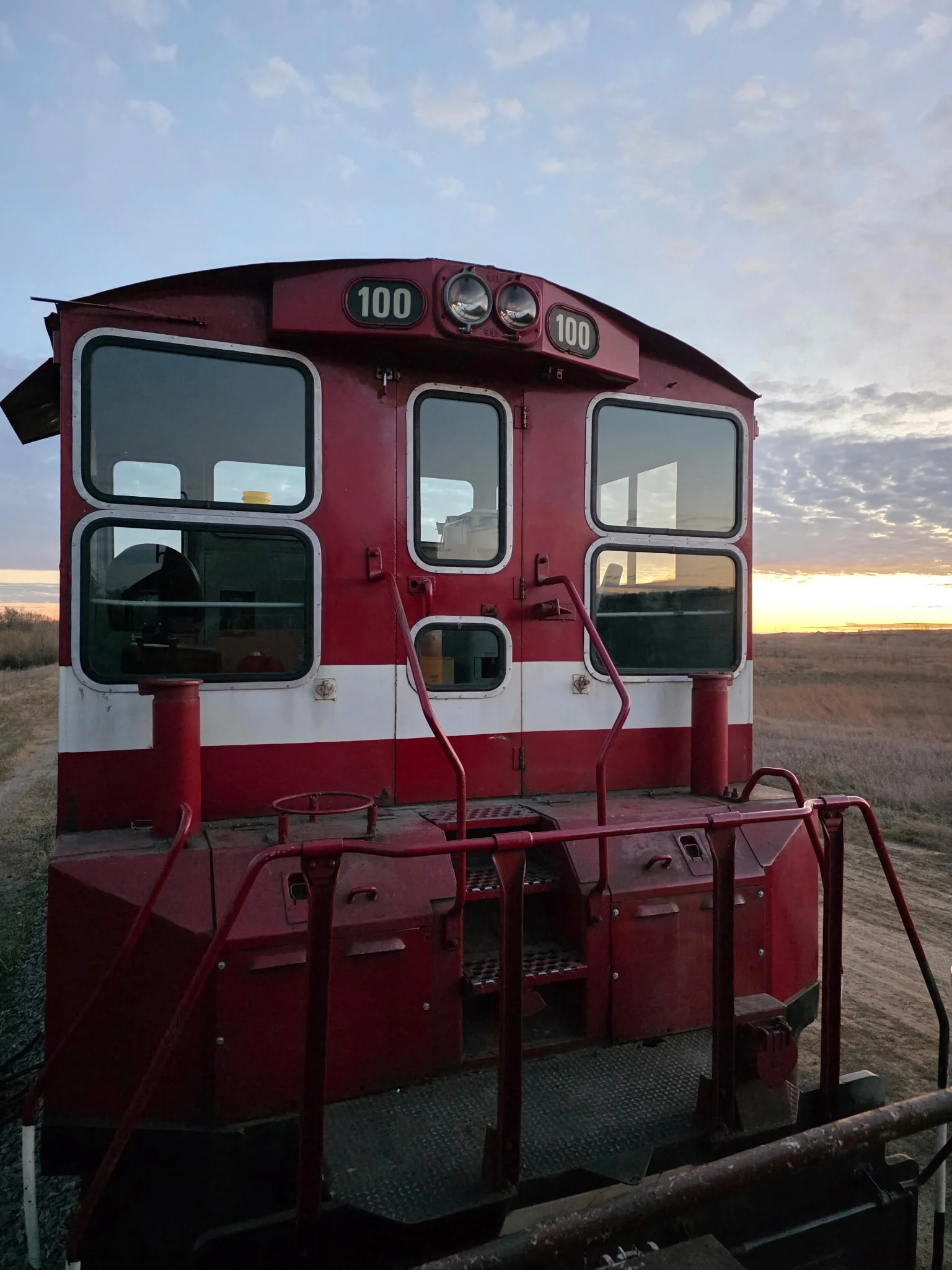 AKRX 1000, EMD SW1000 at sunset with brand new framed window glass.