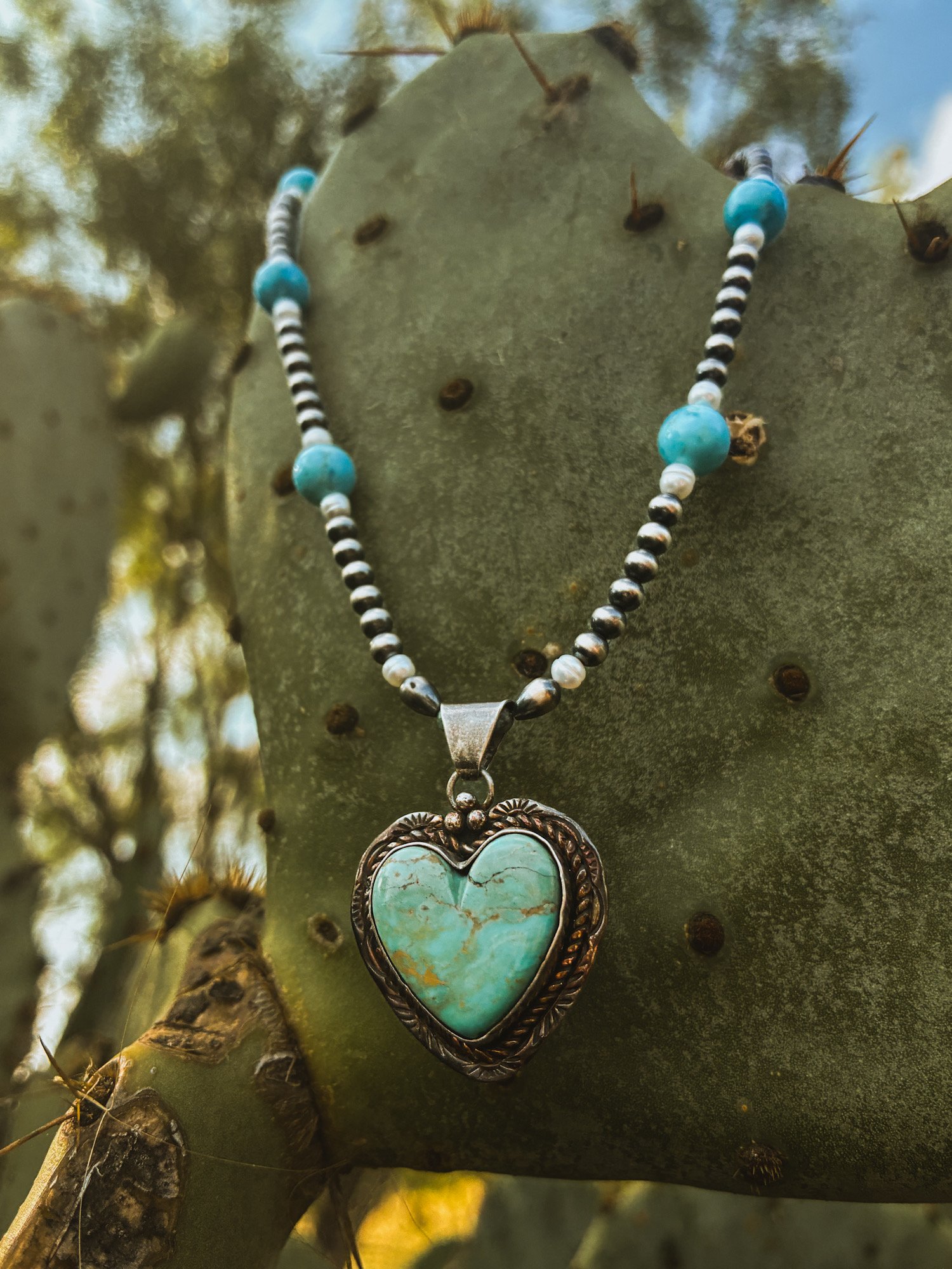 Turquoise heart necklace made by navajo silversmith jason livingston. navajo pearl necklace. western turquoise jewelry