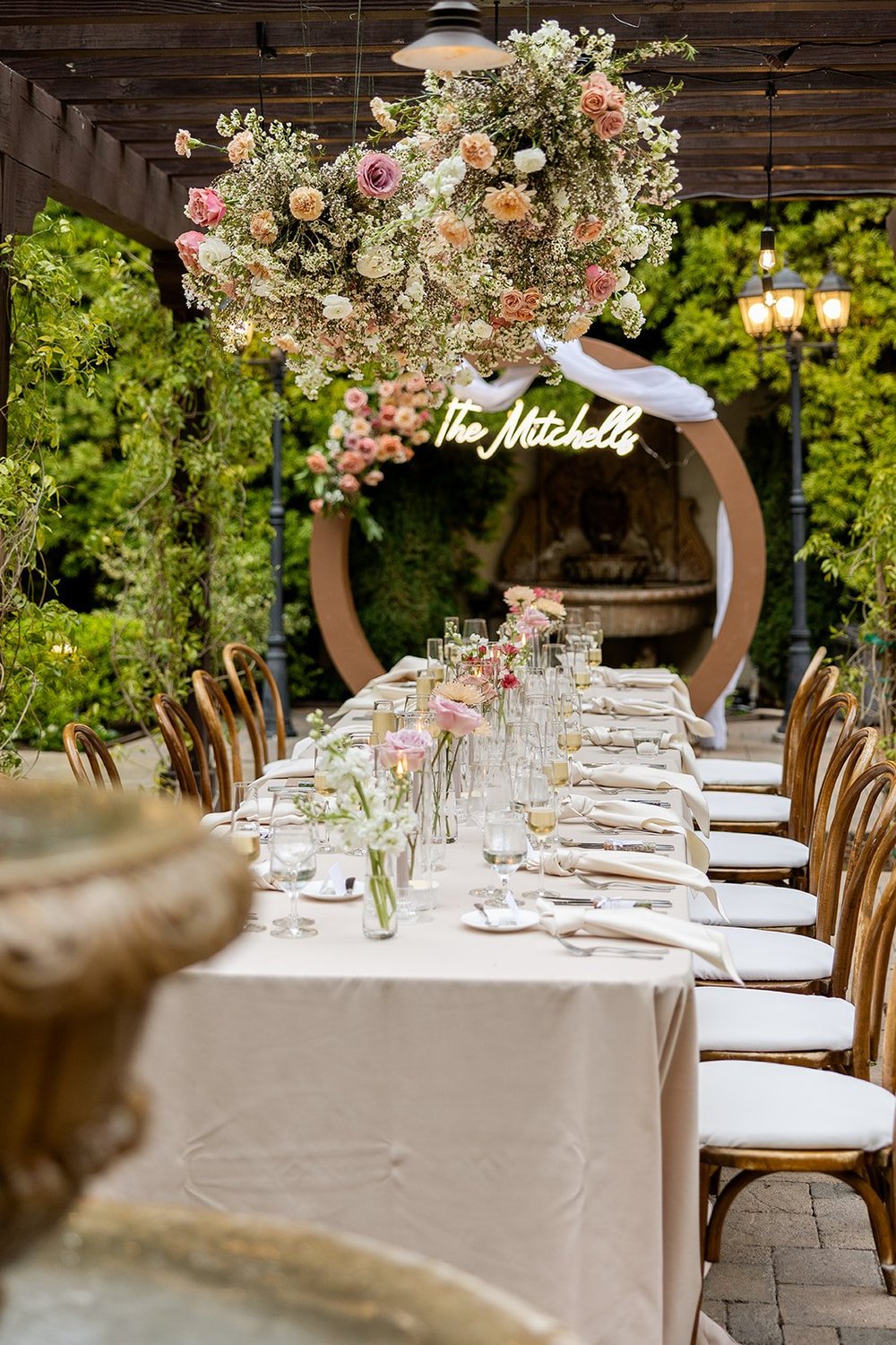 rectange table with bud vases and hanging flower installation