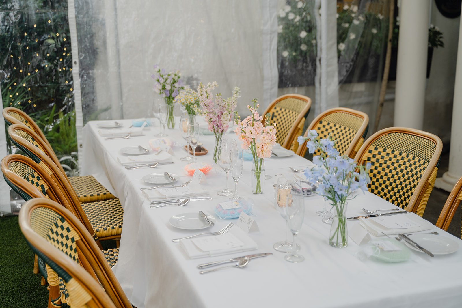 spring flowers in bud vases on wedding reception table