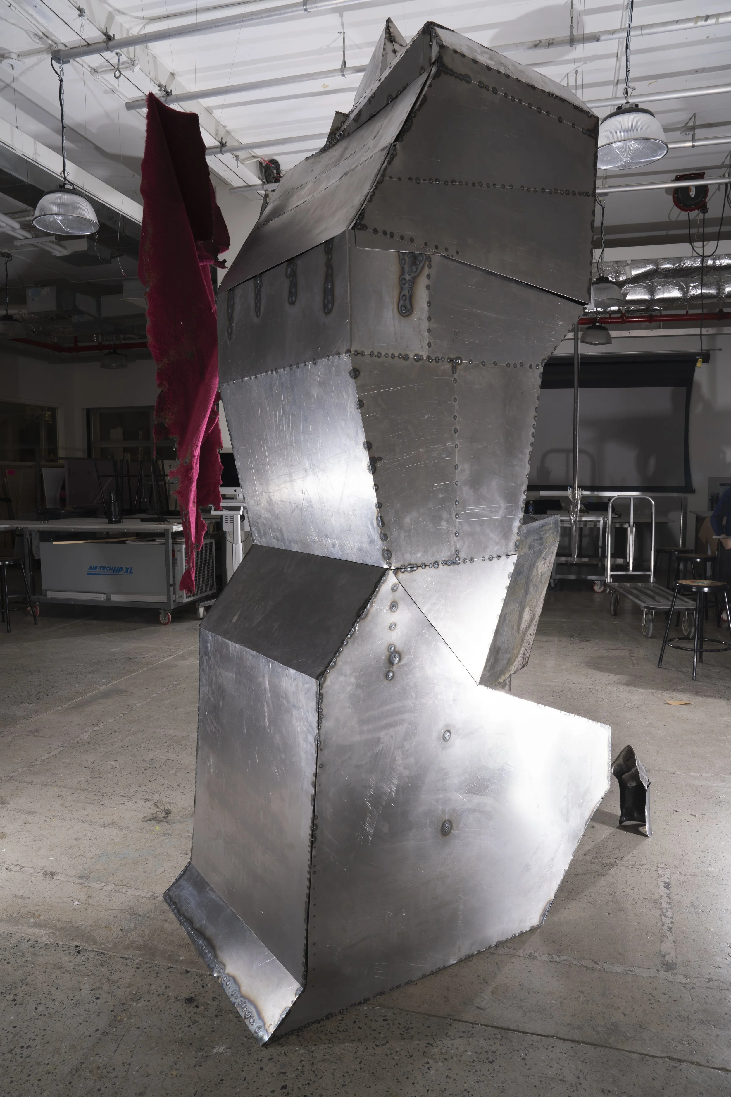 Cold-rolled steel sheets cut, welded, and weathered with patina.
