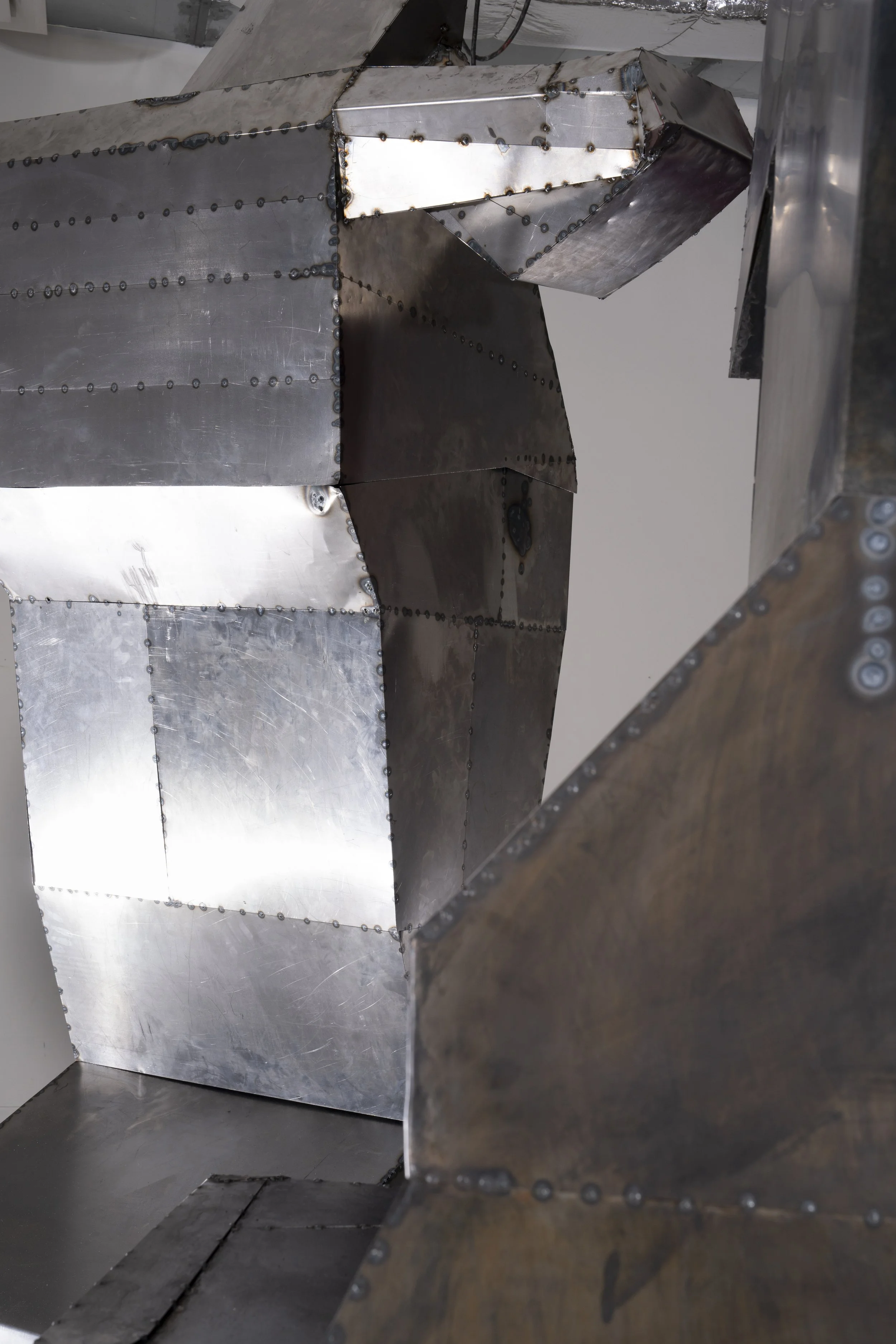Cold-rolled steel sheets cut, welded, and weathered with patina.