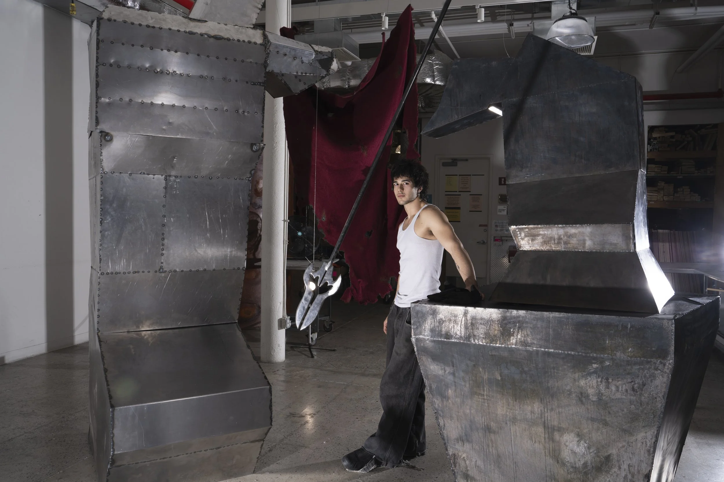 How To Eat A Human Being, 2025. Cold-rolled steel sheets cut, welded, and weathered with patina. Spear made of solid steel articulated through plasma cutting, welding, grinding, polishing, and aged with patina. Jointed poleyn and greave forged with h