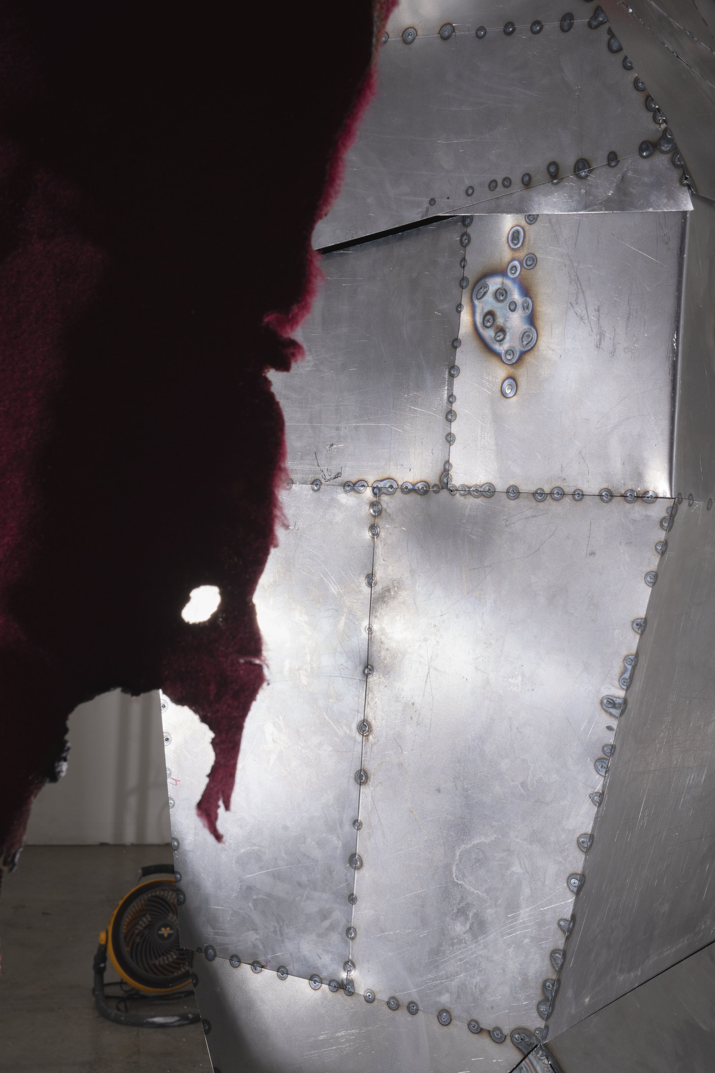 Cold-rolled steel sheets cut, welded, and weathered with patina.