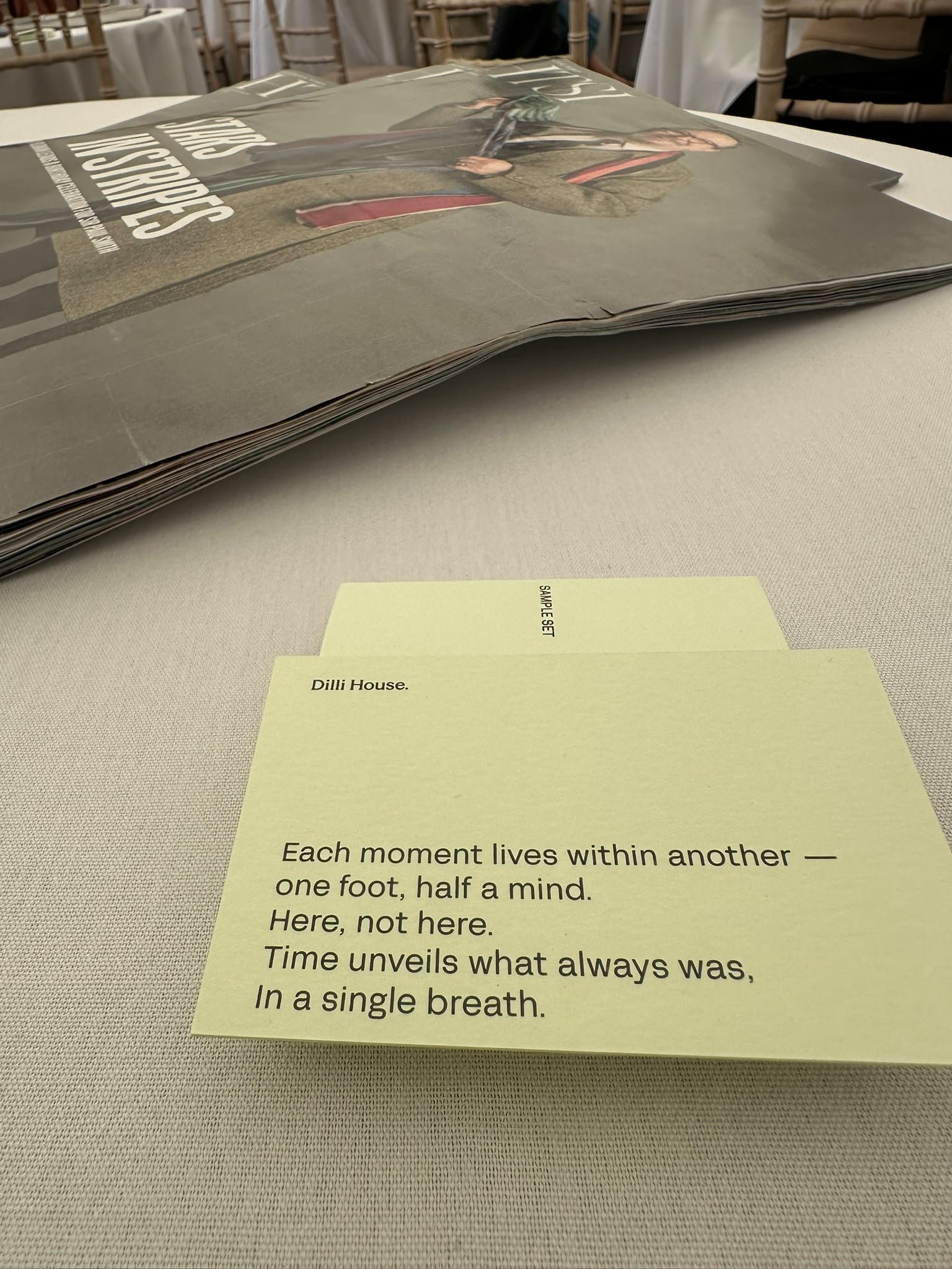 Table with FT HTSI newspaper in the background and a Prem Rouge poem card and fragrance sample