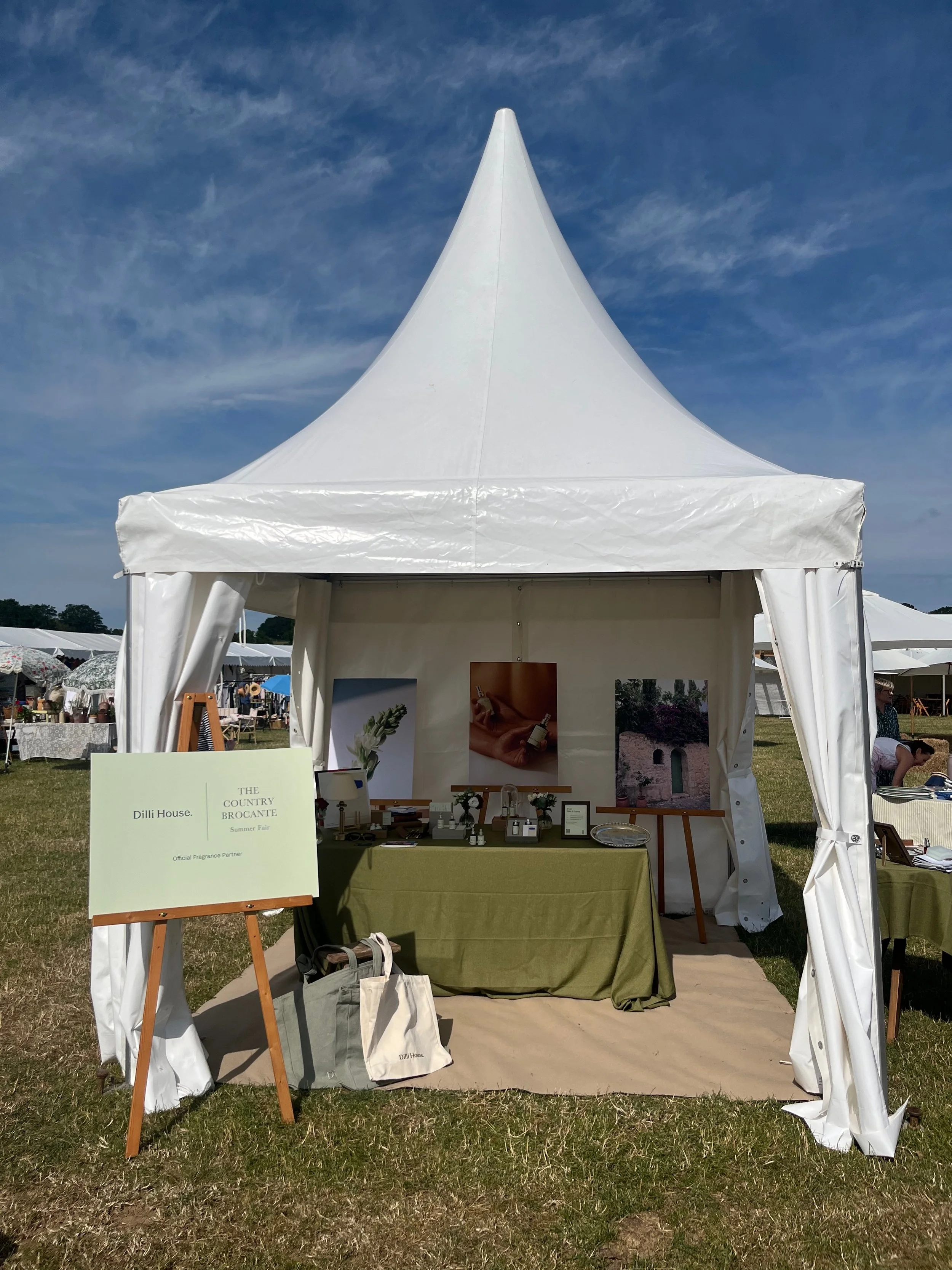 Marquee of Dilli House at the Country Brocante Summer Fair, with the 'Ofiicial Fragrance Partner' board in the front