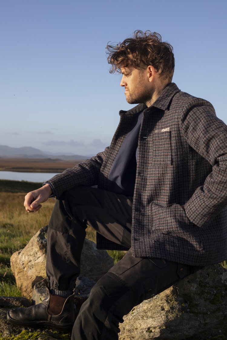 Man in a houndstooth jacket on a green croft