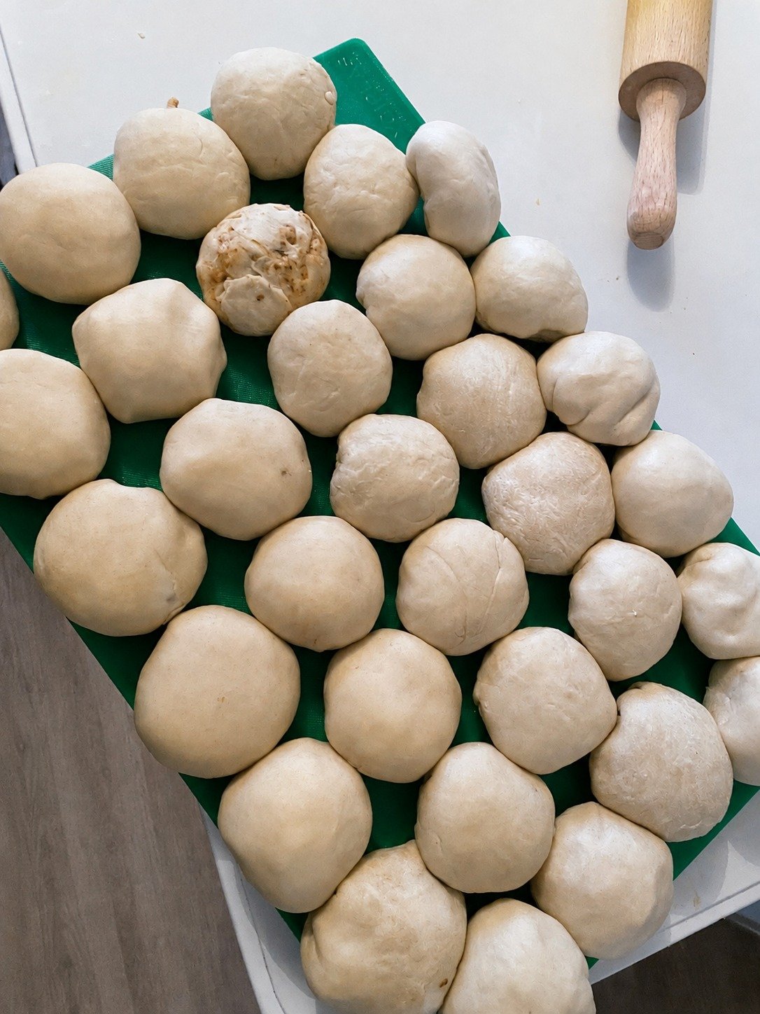 Hand-portioned pastry dough ready to be rolled, stuffed and shaped for handmade Jamaican dumplings by Greek Tings.