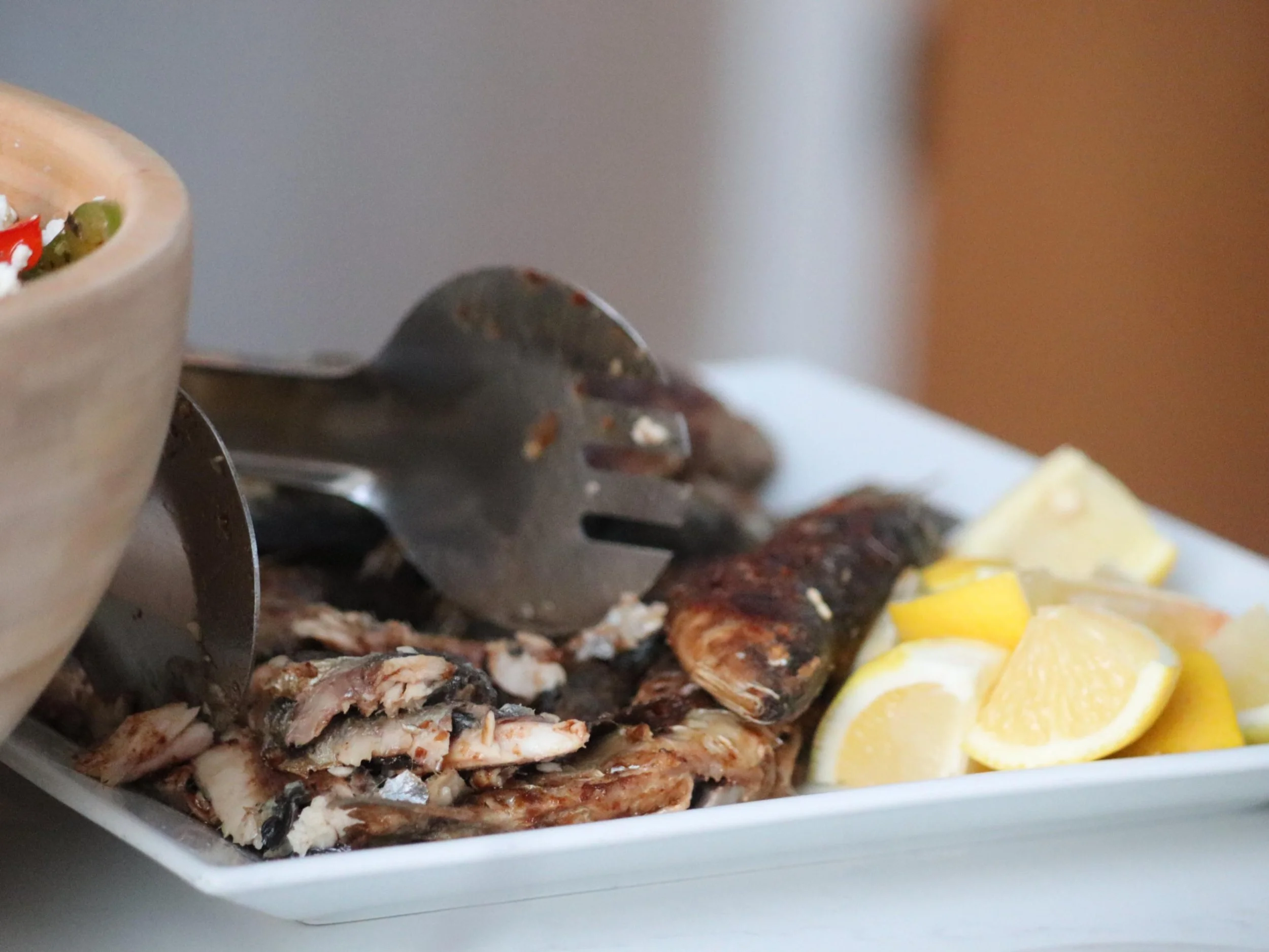 Yiayia-style fried anchovies lightly floured and served with salt and fresh lemon.