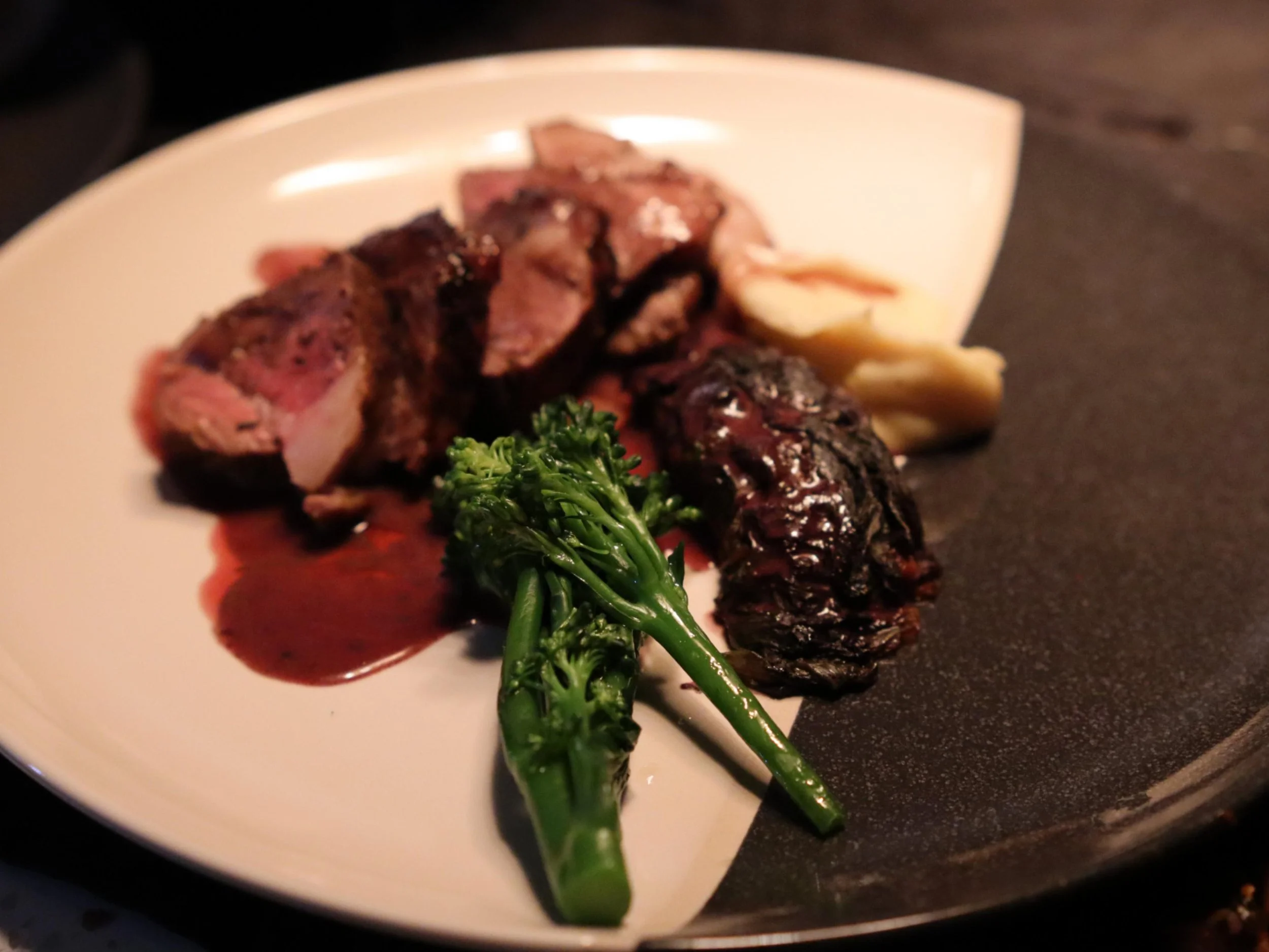 Roasted meat main course with rich jus, broccolini and seasonal vegetables.
