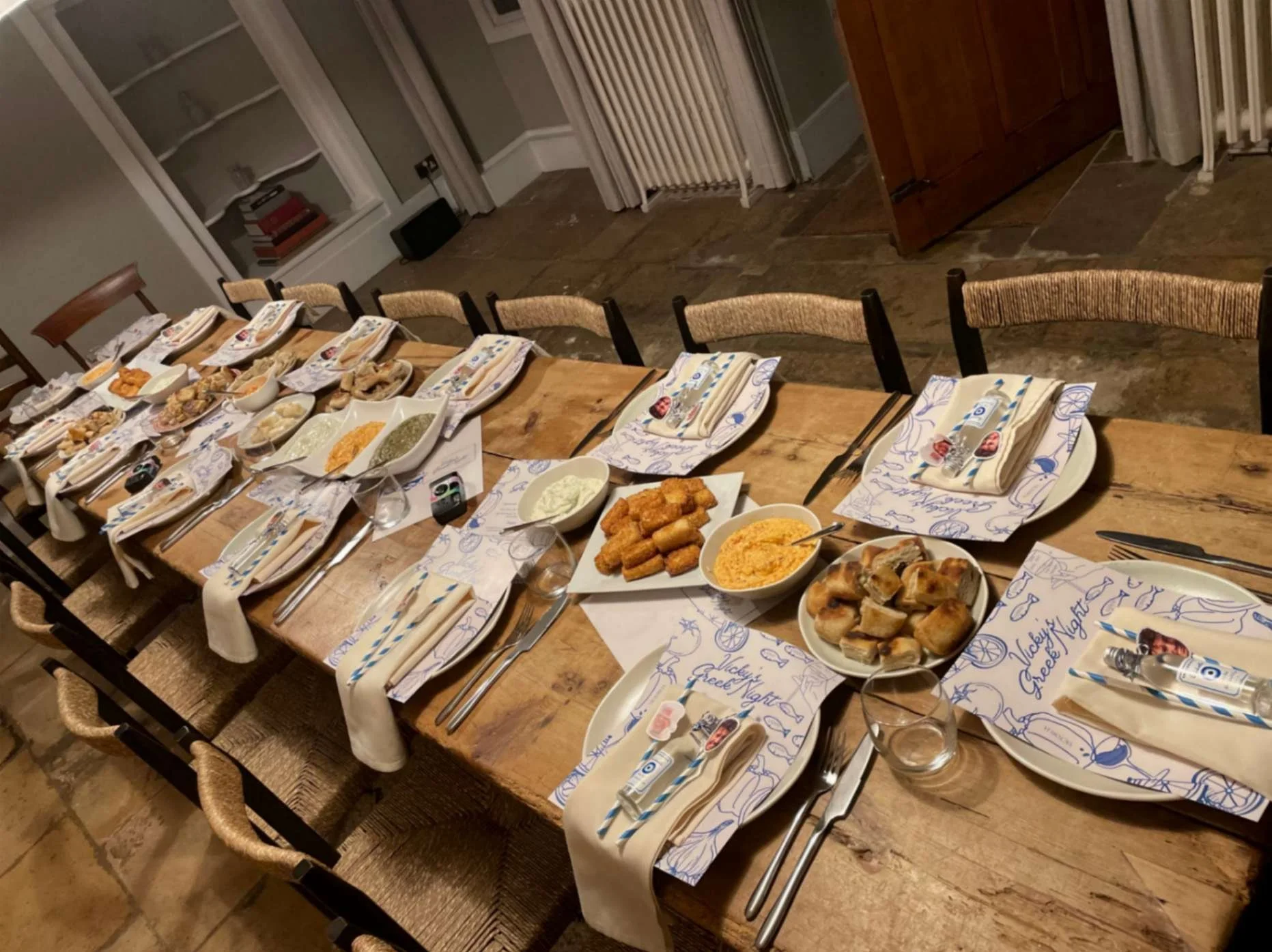 Private dining table set with Greek-inspired place mats, dips and sharing starters by Greek Tings.