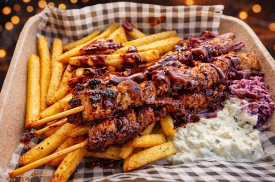 Grilled barbecue skewers served over seasoned fries with slaw and creamy GT jerk sauce.