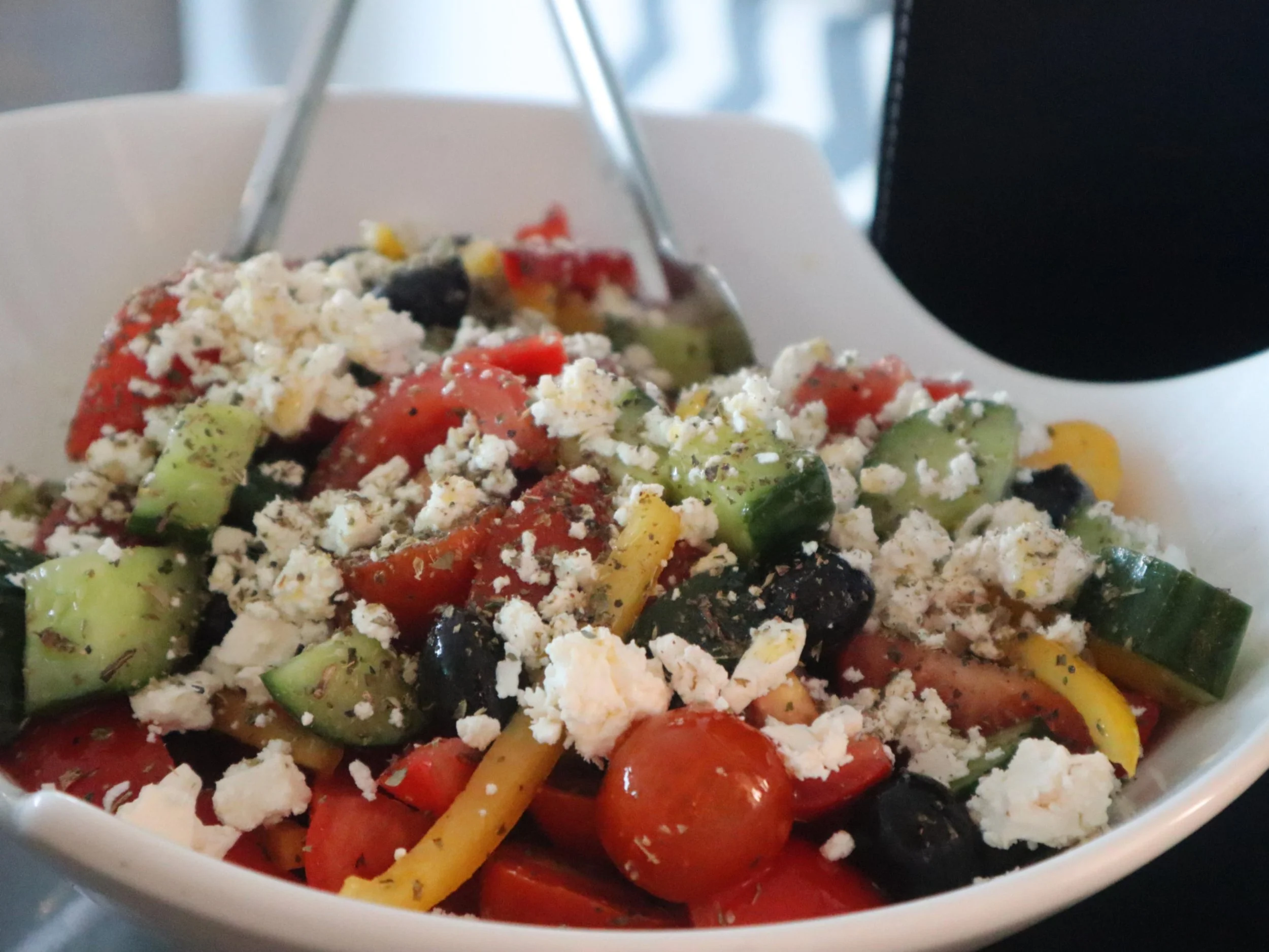 Traditional Greek salad with tomatoes, cucumber, olives, feta, oregano and Greek olive oil.